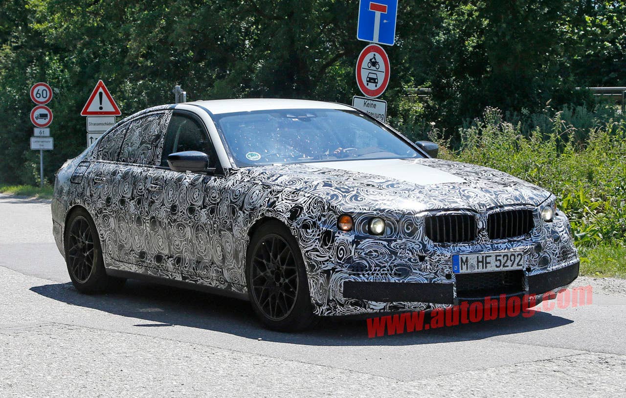 camouflaged bmw m5 spy shots front three quarters