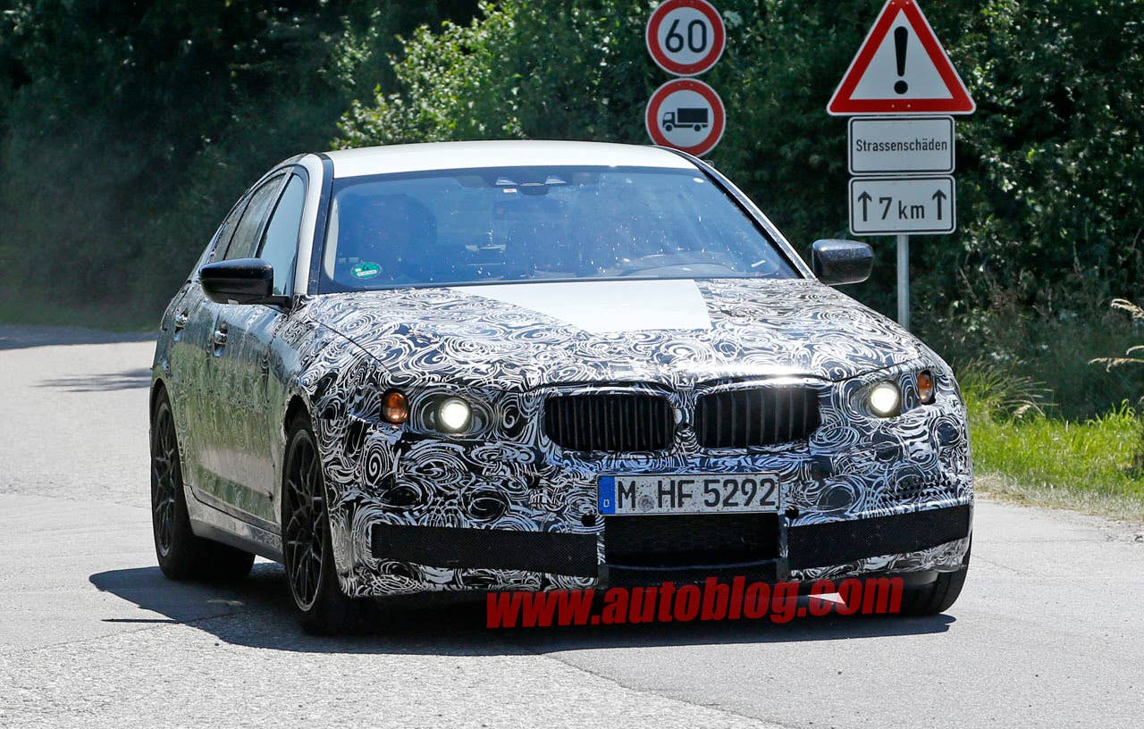 camouflaged bmw m5 spy shots front