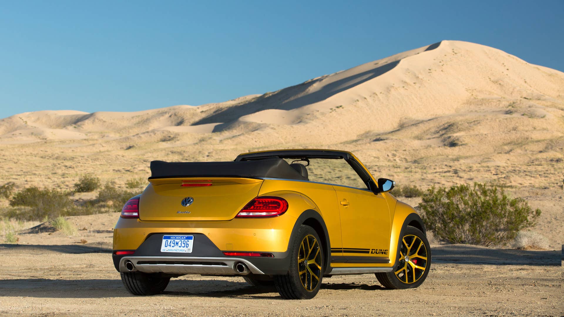 vw beetle dune convertible rear three quarters in desert