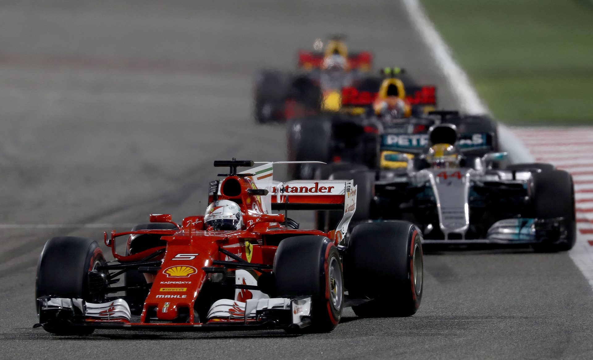BAHRAIN, BAHRAIN - APRIL 16: Sebastian Vettel of Germany driving the (5) Scuderia Ferrari SF70H leads Lewis Hamilton of Great Britain driving the (44) Mercedes AMG Petronas F1 Team Mercedes F1 WO8 on track during the Bahrain Formula One Grand Prix at Bahrain International Circuit on April 16, 2017 in Bahrain, Bahrain. (Photo by Lars Baron/Getty Images)