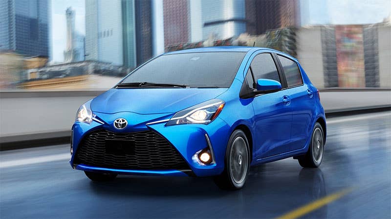 A blue 2018 Toyota Yaris hatchback, front three-quarter view.