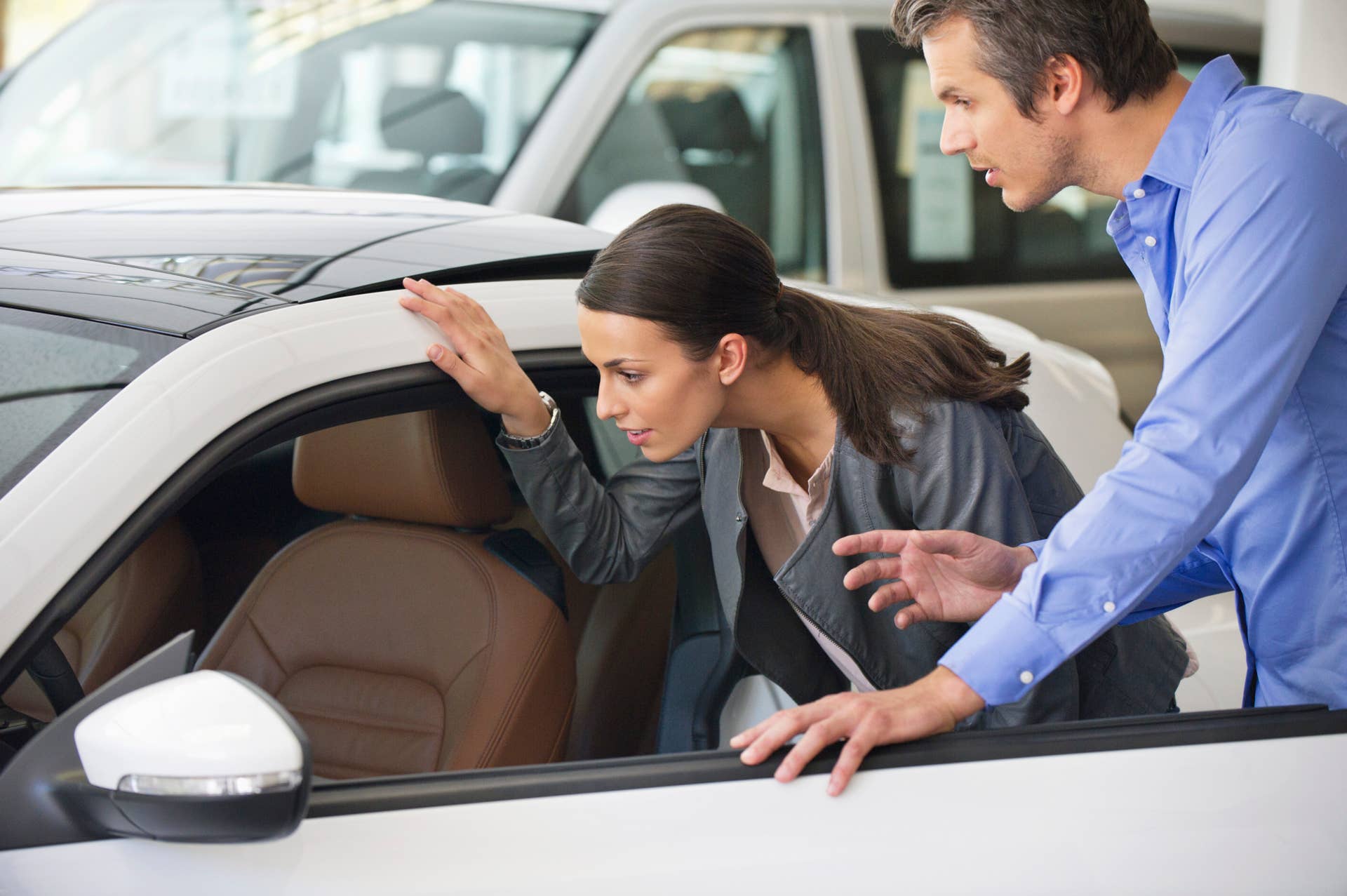 Couple examining a car before buying