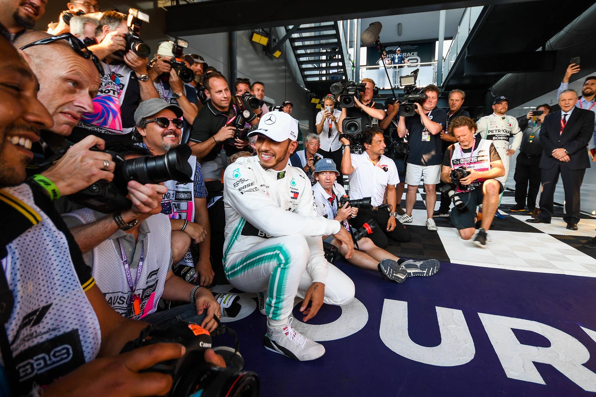 Lewis Hamilton of Great Britain and Mercedes takes a photo with photographers after taking pole position for the Australian Formula 1 Grand Prix at Albert Park on March 16, 2019 in Melbourne, Australia (Photo by Morgan Hancock/NurPhoto via Getty Images)