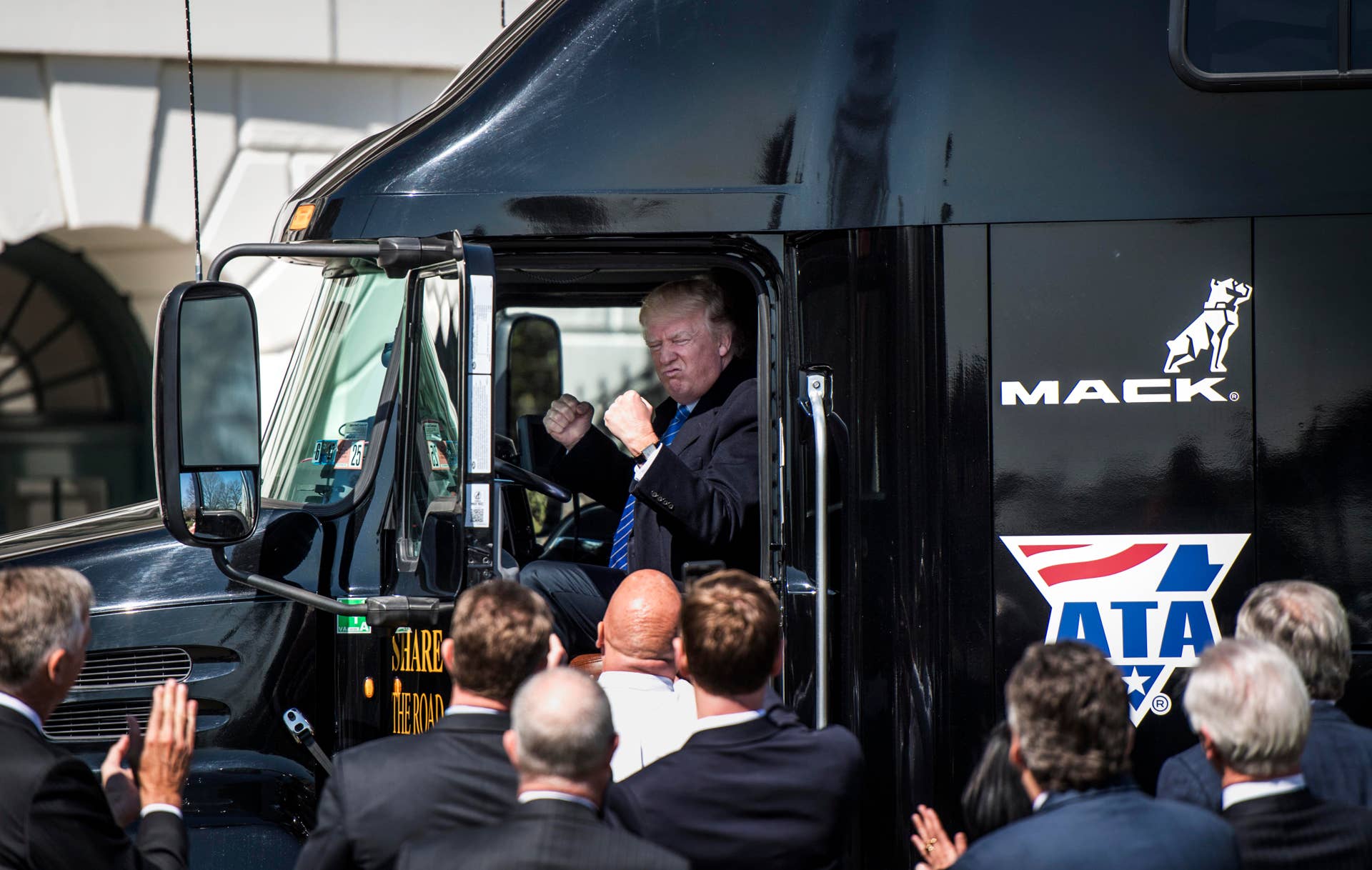 WASHINGTON, DC - President Donald Trump jumps up in the cab of an 18 wheeler truck while meeting with truckers and CEOs regarding healthcare on the South Lawn of the White House in Washington, DC Thursday March 23, 2017. (Photo by Melina Mara/The Washington Post via Getty Images)
