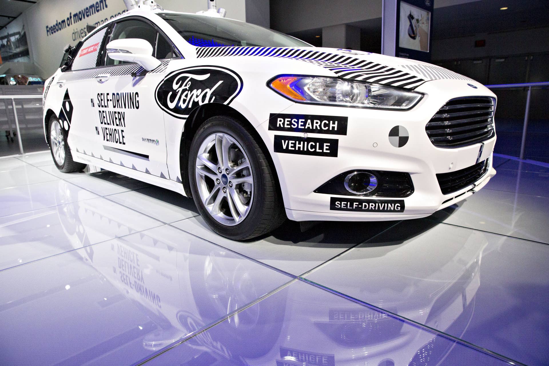 A Ford Motor Co. Fusion set-up as an experimental self-driving delivery vehicle sits on display during the 2018 North American International Auto Show (NAIAS) in Detroit, Michigan, U.S., on Monday, Jan. 15, 2018. After auto executives spent years trying to convince the world they can beat Silicon Valley to electric cars and autonomous driving, they are finally getting a chance to crow once again about what they do best: trucks. Each of the hometown brands will pull the cover off of a new flatbed, while at least three of the luxury brands roll out new SUVs. Photographer: Daniel Acker/Bloomberg via Getty Images