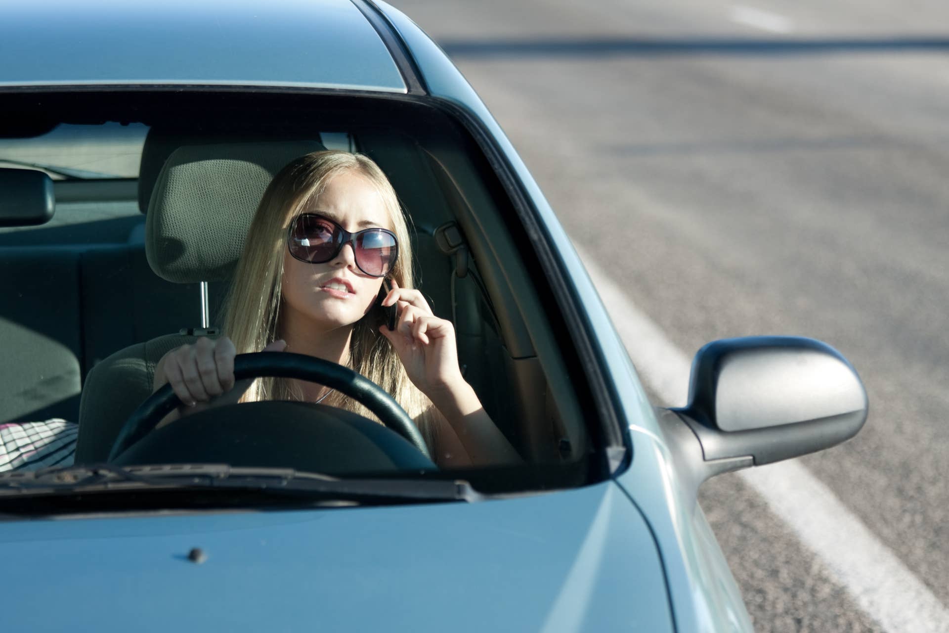 woman talking in the car by...