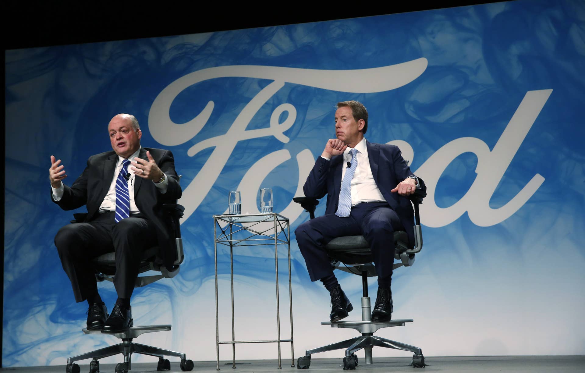 Jim Hackett, incoming chief executive officer of Ford Motor Co., left, speaks as Bill Ford, executive chairman of Ford Motor Co., listens during an event at the company's headquarters in Dearborn, Michigan, U.S., on Tuesday, May 22, 2017. Ford Motor Co.ï¿½is replacing embattled chief executive officerï¿½Mark Fieldsï¿½withï¿½Hackett,ï¿½a turnaround specialist who has been leading the automaker's moves into self-driving cars and ride sharing. Photographer: Jeff Kowalsky/Bloomberg via Getty Images