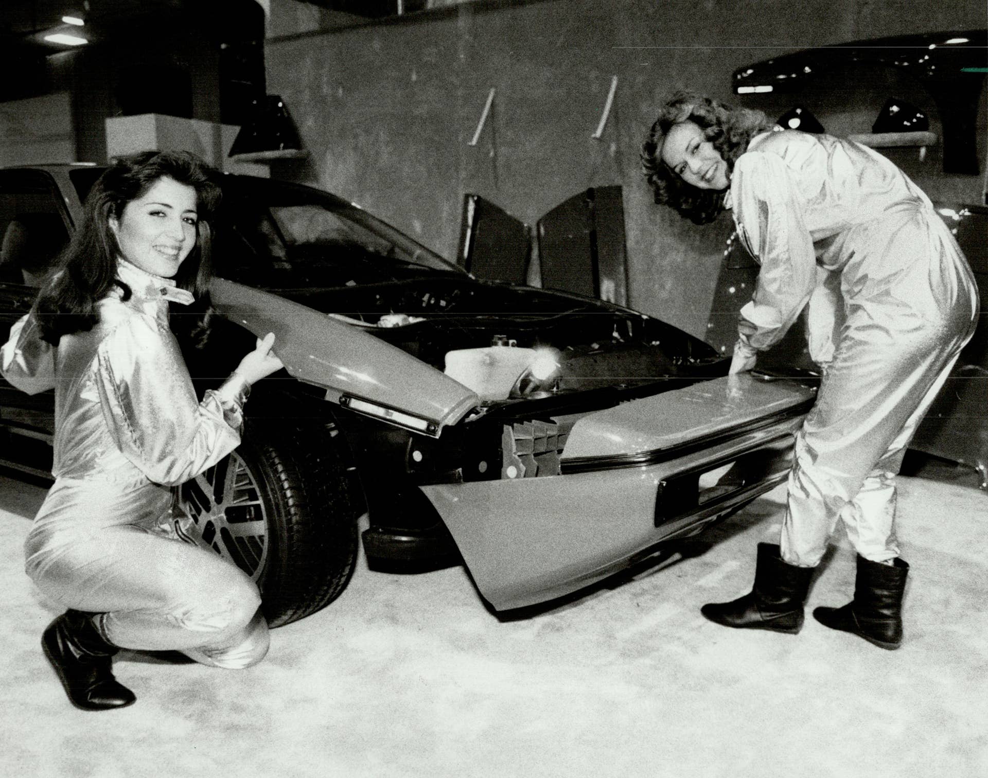 CANADA - FEBRUARY 09: That's some bodywork. Two models bolted the plastic base body of this Pontiac Fiero together in 2 minutes yesterday at the International Centre (home of the Auto Show unit Feb. 19). On left; Camilla Scott and Lea Parrell (right) position roof on the frame; Above Scott handles the right fender; Parrell the front panel. Below they show the finished product that General Motors hopes will keep repair costs down in the event a panel gets dinged. (Photo by John Mahler/Toronto Star via Getty Images)