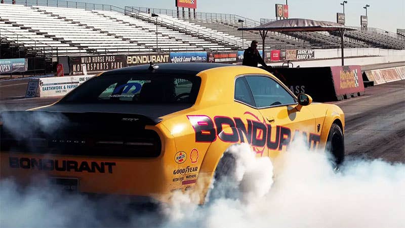 A yellow Dodge Demon does a burnout at the Bob Bondurant School of High Performance Driving.