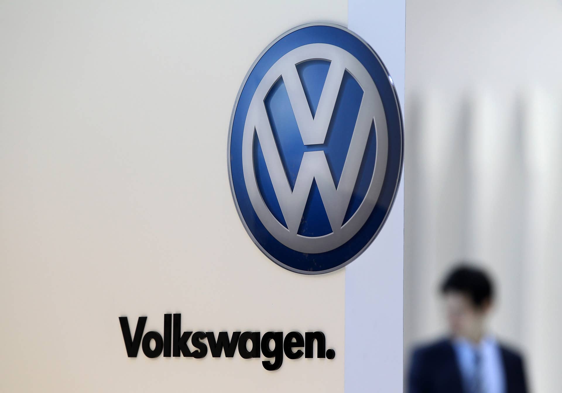 The Volkswagen AG logo is displayed at the company's booth during the media preview of the 2012 Busan International Motor Show in Busan, South Korea, on Thursday, May 24, 2012. The motor show takes place from May 25 to June 3. Photographer: SeongJoon Cho/Bloomberg via Getty Images