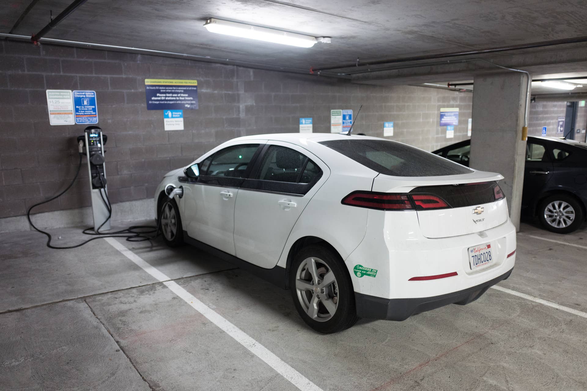Chevrolet Volt electric automobile plugged in and charging in a parking garage, with a Clean Air Vehicle (CAV) decal reading Clean Air Access Okay, October 3, 2016. The decals, which allow a single occupant vehicle to drive in a carpool lane, are issued to electric vehicle drivers in California. (Photo via Smith Collection/Gado/Getty Images).