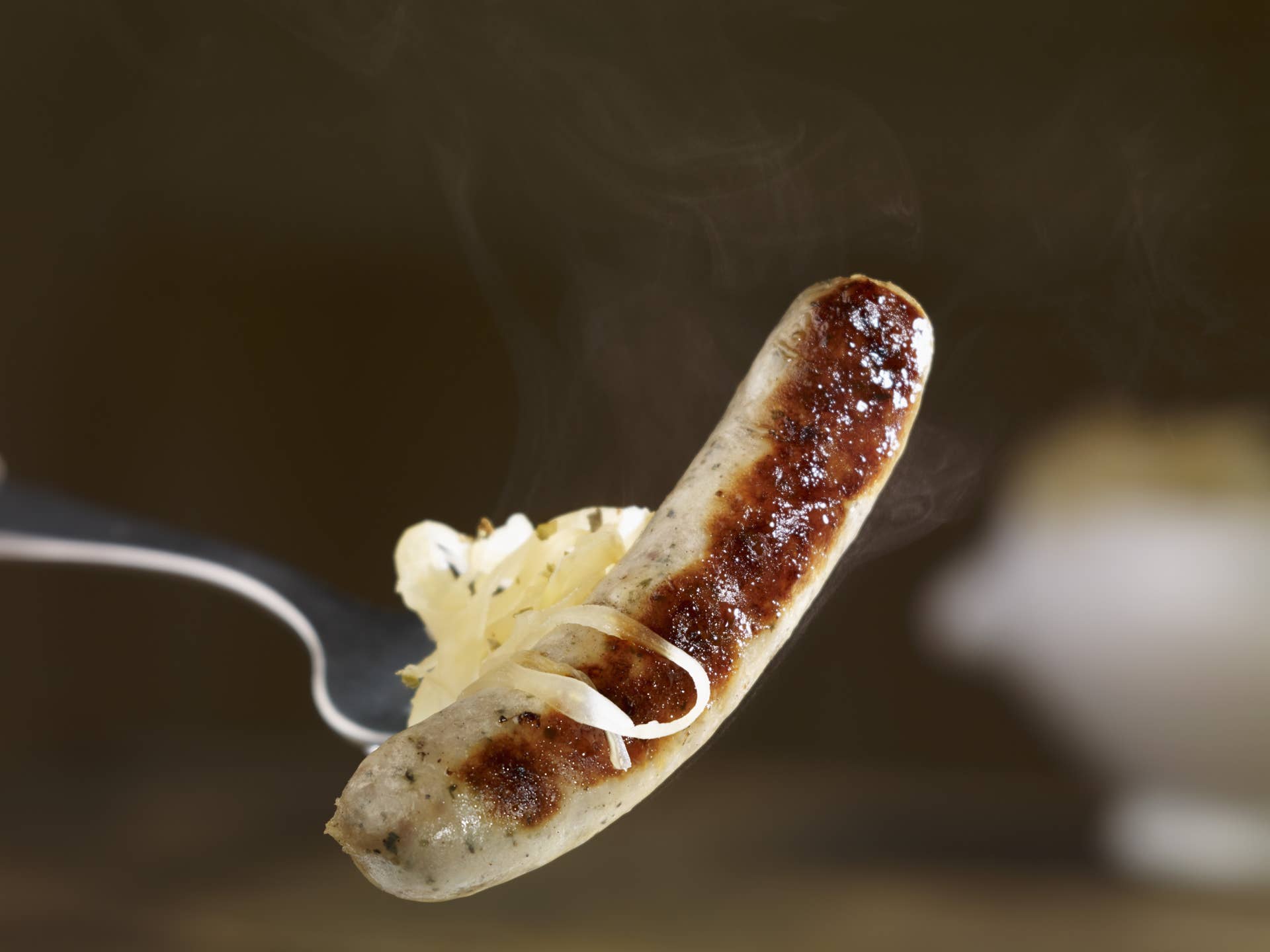Steaming grilled bratwurst sausage with sauerkraut