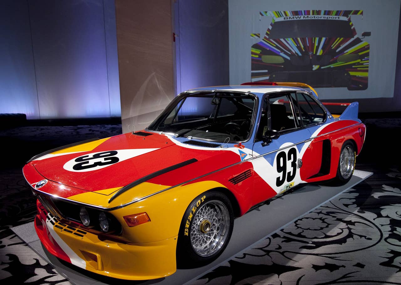 The Alexander Calder BMW Art Car at a news conference in New York where BMW announced it's return to the Le Mans 24 hour race on Tuesday, April 6, 2010. The next BMW Art Car artist Jeff Koons design concept for the 17th BMW Art Car in background. (Jim Sulley/newscast) (04/2010)