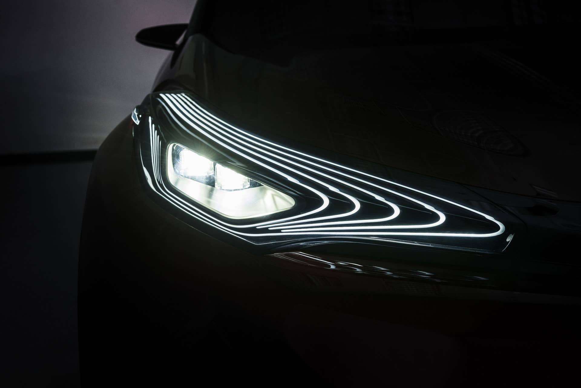 The Scion C-HR concept shown off in red for the LA Auto Show, illuminated headlight.