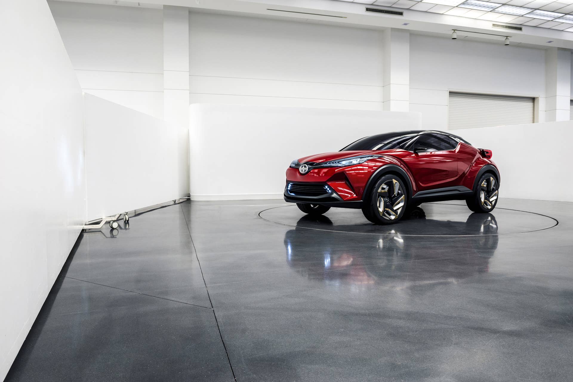 The Scion C-HR concept shown off in red for the LA Auto Show, indoor front three-quarter.