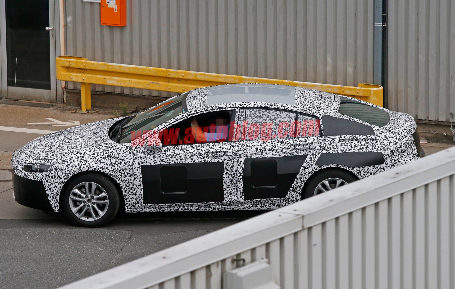 spied fence wall opel insignia camo hatchback