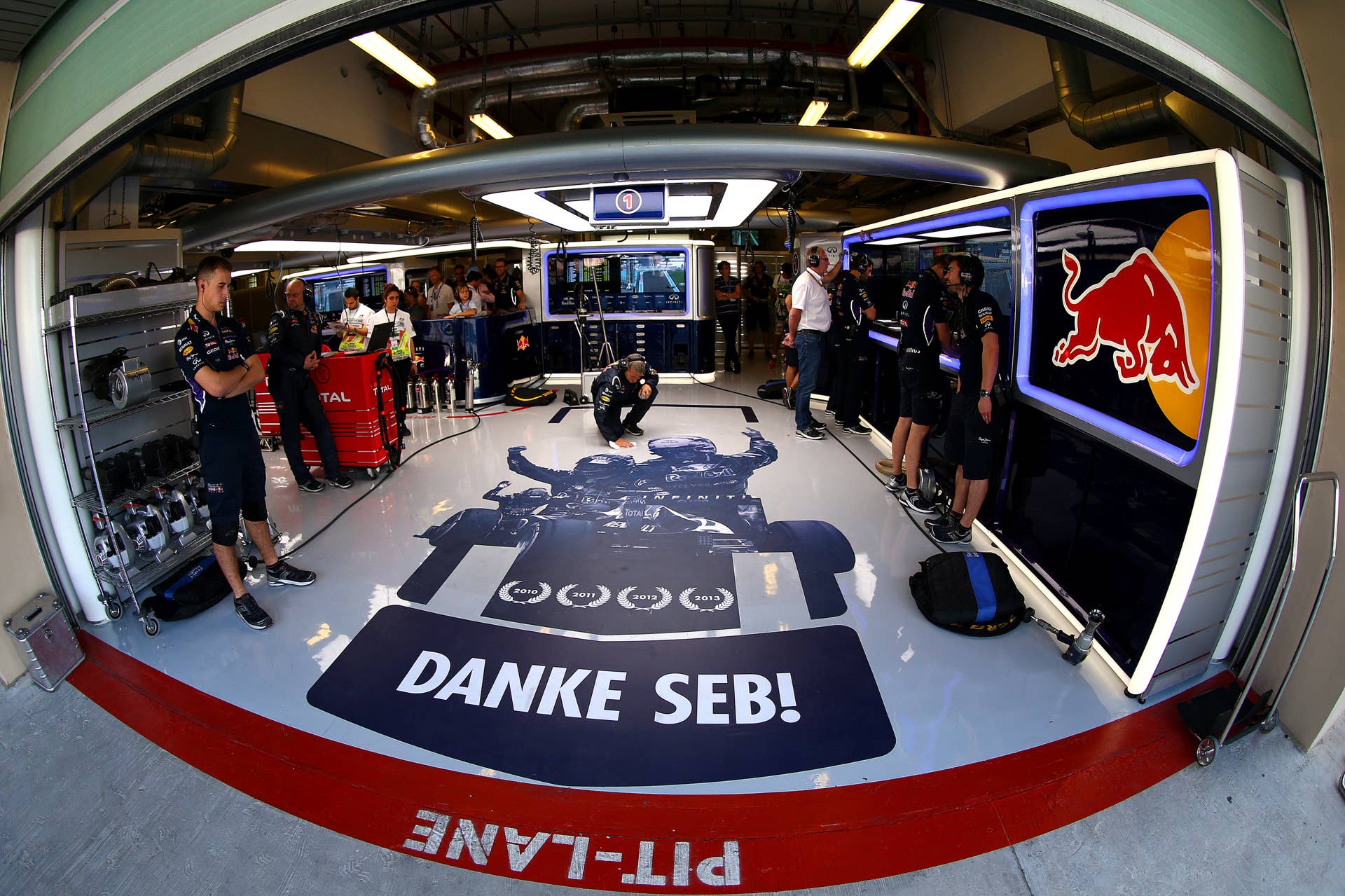 ABU DHABI, UNITED ARAB EMIRATES - NOVEMBER 22:  A message from the team to Sebastian Vettel of Germany and Infiniti Red Bull Racing is displayed on the floor of the garage during final practice ahead of the Abu Dhabi Formula One Grand Prix at Yas Marina Circuit on November 22, 2014 in Abu Dhabi, United Arab Emirates.  (Photo by Dan Istitene/Getty Images)