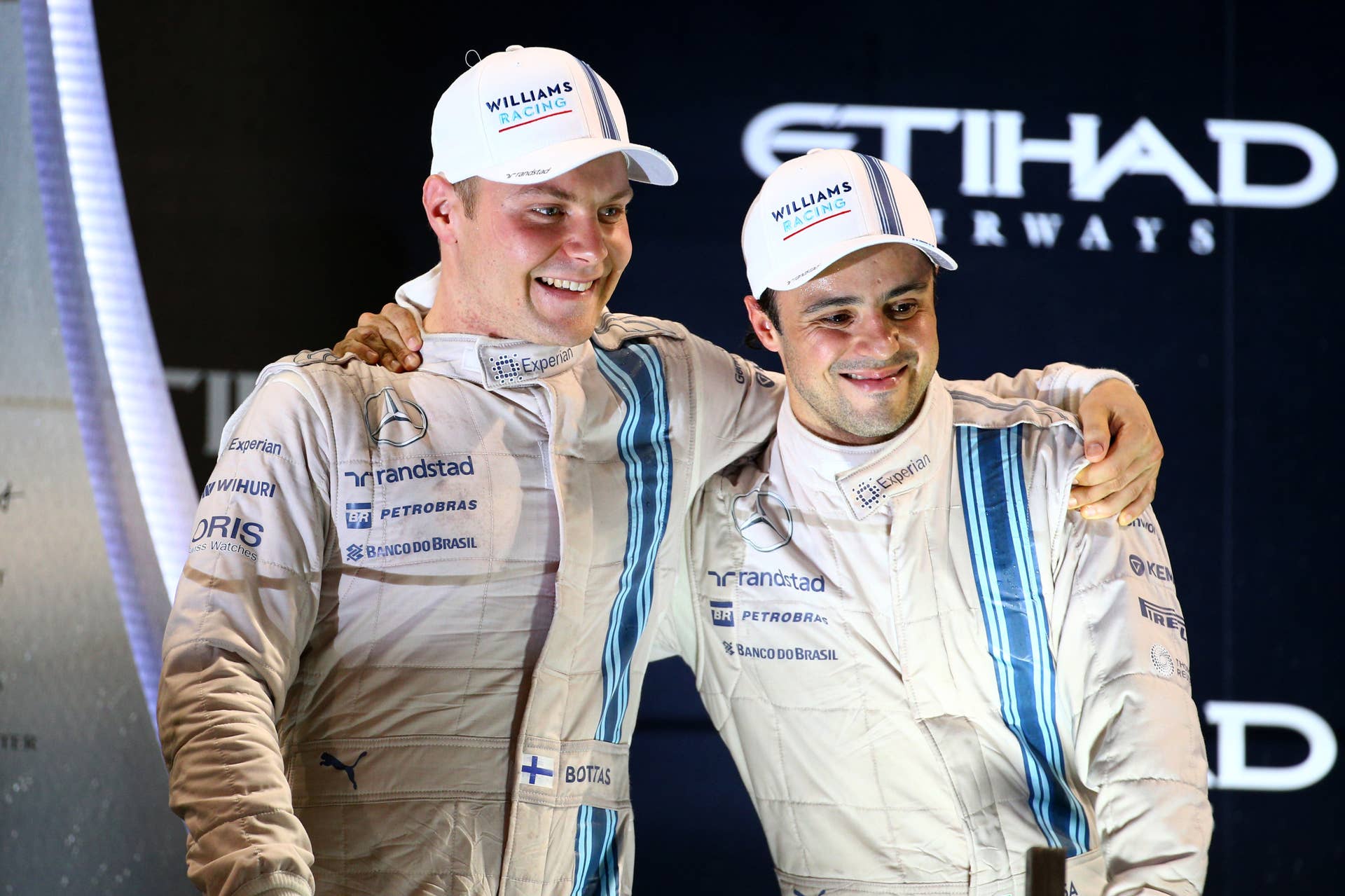 ABU DHABI, UNITED ARAB EMIRATES - NOVEMBER 23:  Valtteri Bottas of Finland and Williams celebrates on the podium with Felipe Massa of Brazil and Williams after finisihing third and second respectively in the Abu Dhabi Formula One Grand Prix at Yas Marina Circuit on November 23, 2014 in Abu Dhabi, United Arab Emirates.  (Photo by Mark Thompson/Getty Images)