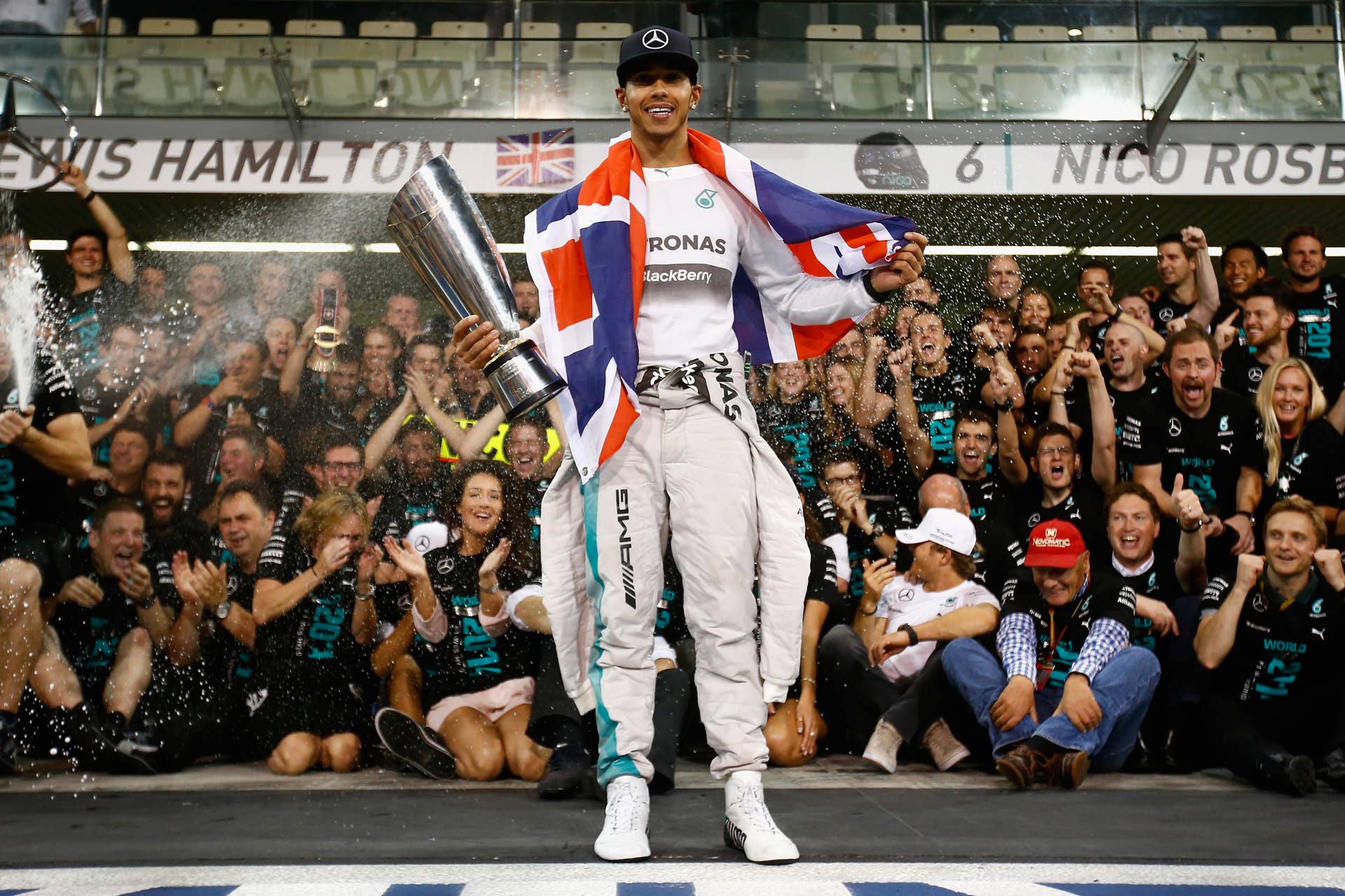 ABU DHABI, UNITED ARAB EMIRATES - NOVEMBER 23:  Lewis Hamilton of Great Britain and Mercedes GP celebrates with his team after winning the World Championship after the Abu Dhabi Formula One Grand Prix at Yas Marina Circuit on November 23, 2014 in Abu Dhabi, United Arab Emirates.  (Photo by Clive Rose/Getty Images)