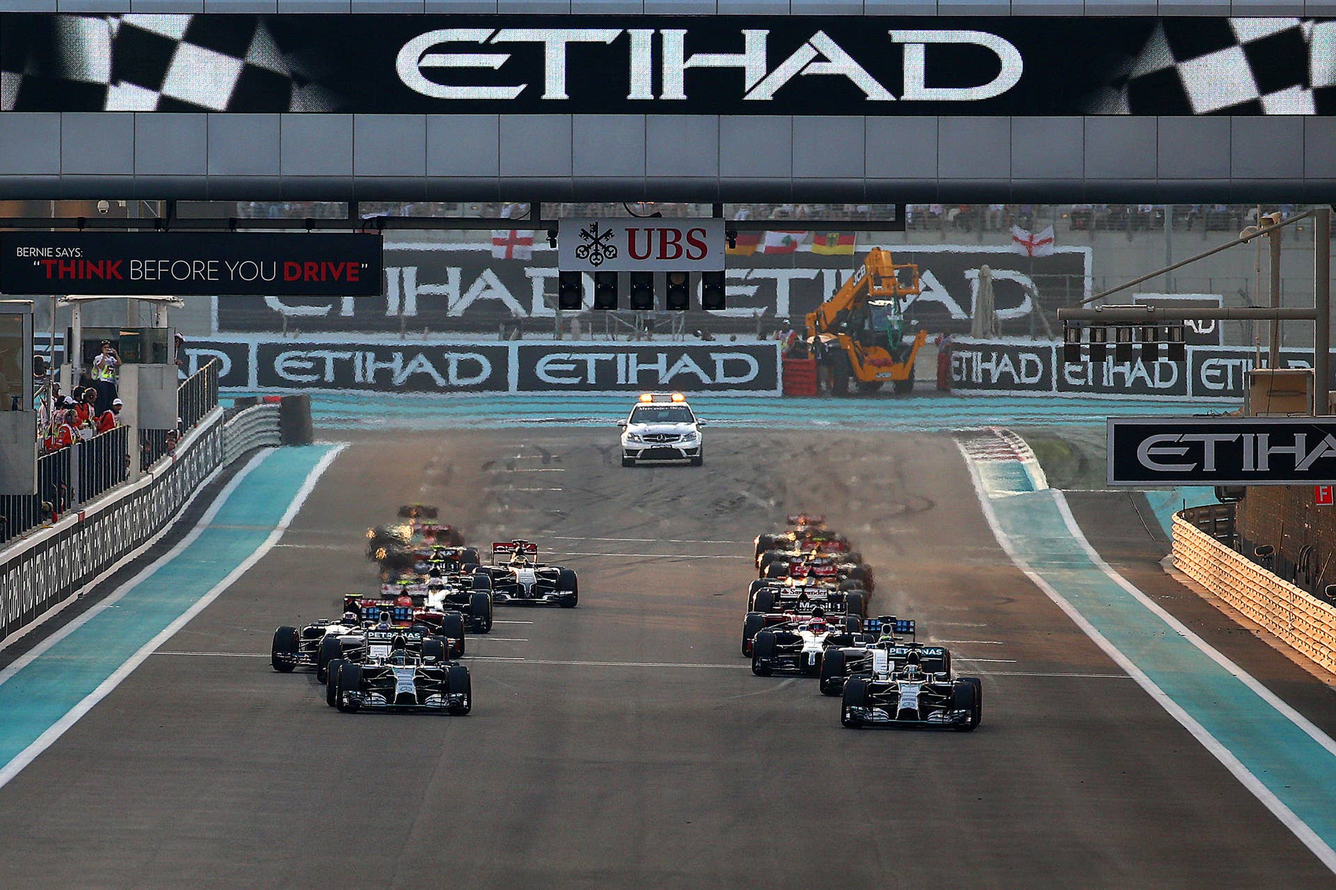 ABU DHABI, UNITED ARAB EMIRATES - NOVEMBER 23:  Lewis Hamilton of Great Britain and Mercedes GP pulls away into first ahead of Nico Rosberg of Germany and Mercedes GP and the rest of the field at the start of the Abu Dhabi Formula One Grand Prix at Yas Marina Circuit on November 23, 2014 in Abu Dhabi, United Arab Emirates.  (Photo by Mark Thompson/Getty Images)