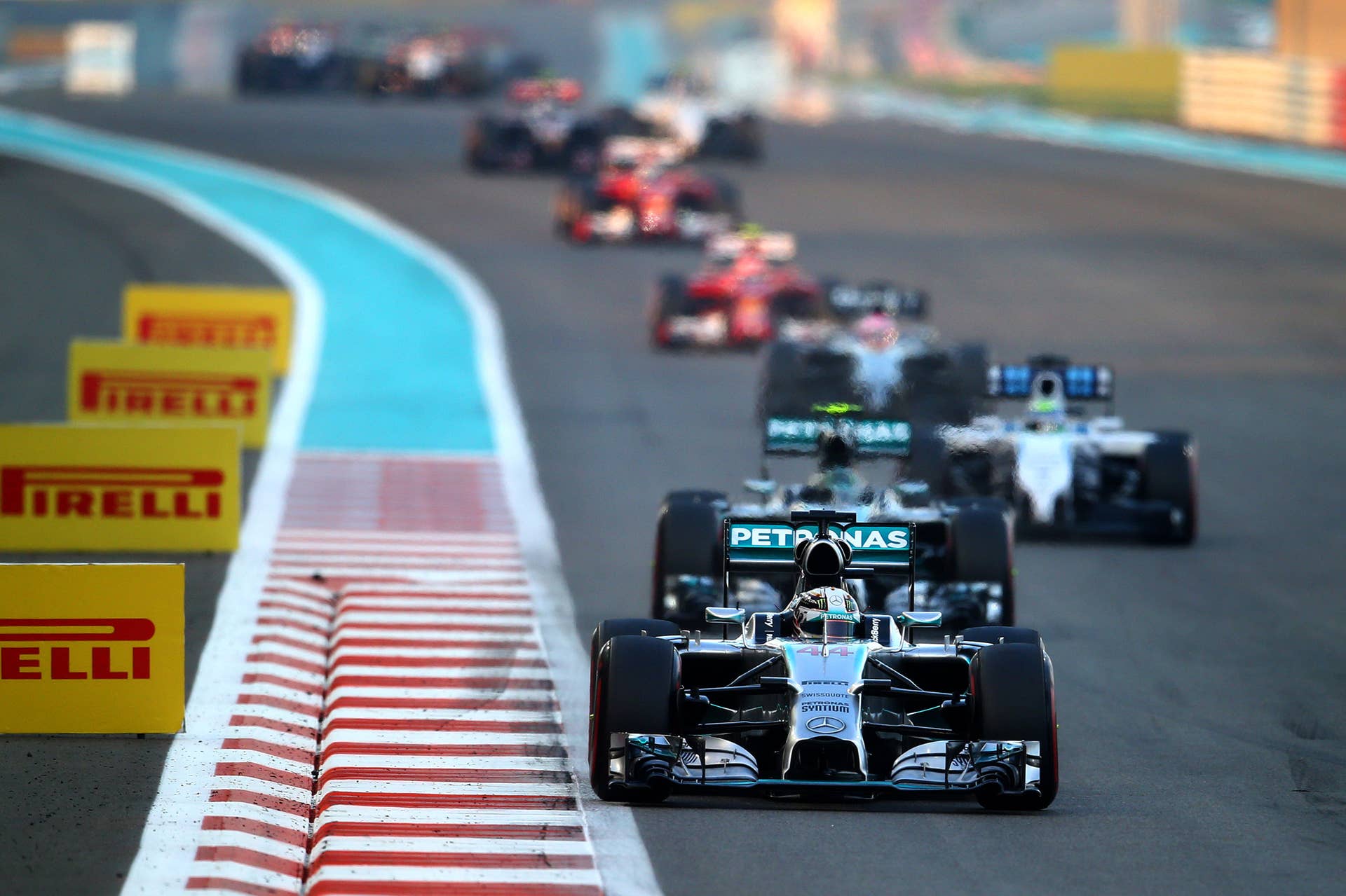 ABU DHABI, UNITED ARAB EMIRATES - NOVEMBER 23:  Lewis Hamilton of Great Britain and Mercedes GP leads Nico Rosberg of Germany and Mercedes GP during the Abu Dhabi Formula One Grand Prix at Yas Marina Circuit on November 23, 2014 in Abu Dhabi, United Arab Emirates.  (Photo by Clive Rose/Getty Images)