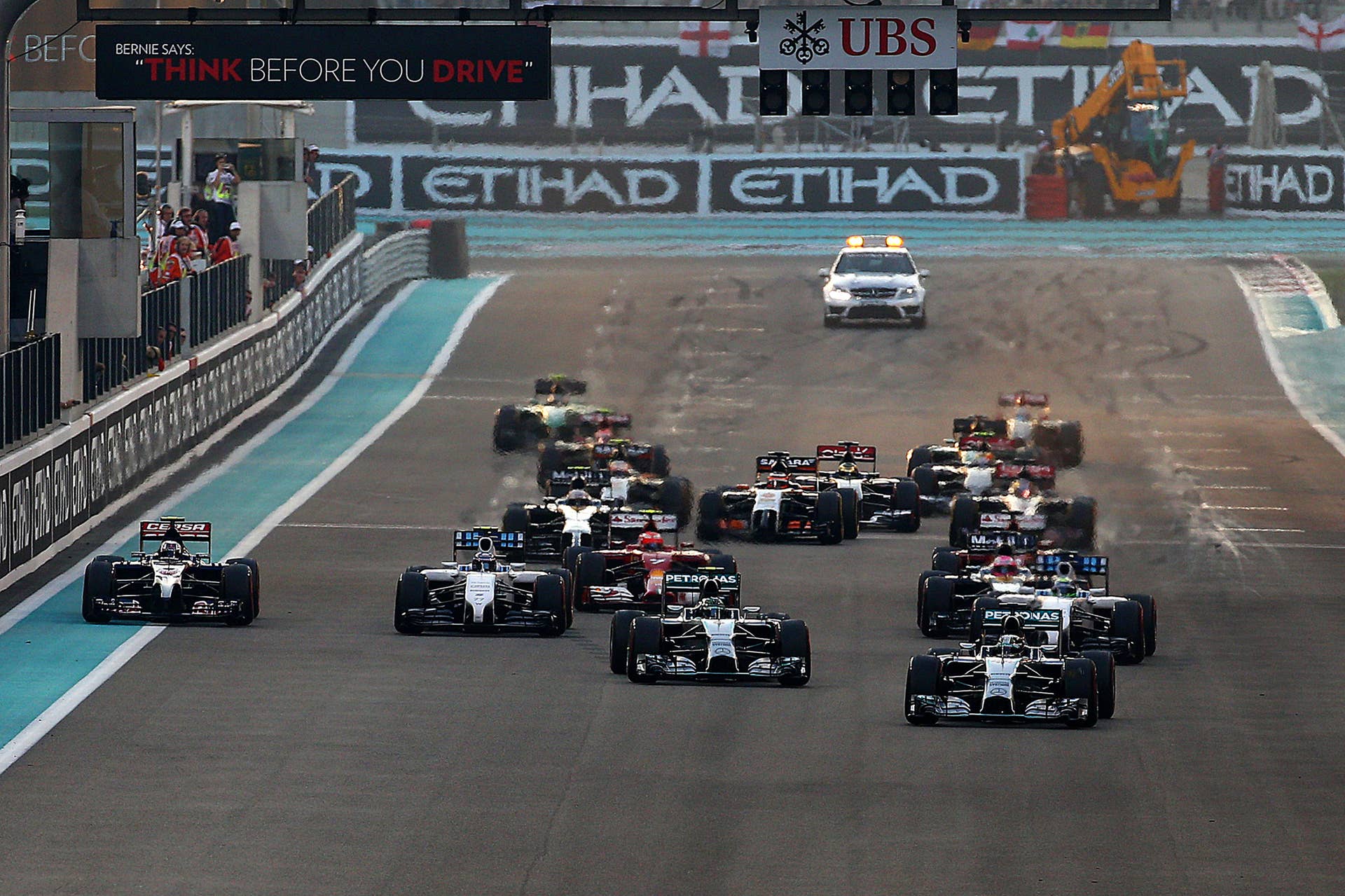 ABU DHABI, UNITED ARAB EMIRATES - NOVEMBER 23:  Lewis Hamilton of Great Britain and Mercedes GP pulls away into first ahead of Nico Rosberg of Germany and Mercedes GP and the rest of the field at the start of the Abu Dhabi Formula One Grand Prix at Yas Marina Circuit on November 23, 2014 in Abu Dhabi, United Arab Emirates.  (Photo by Mark Thompson/Getty Images)