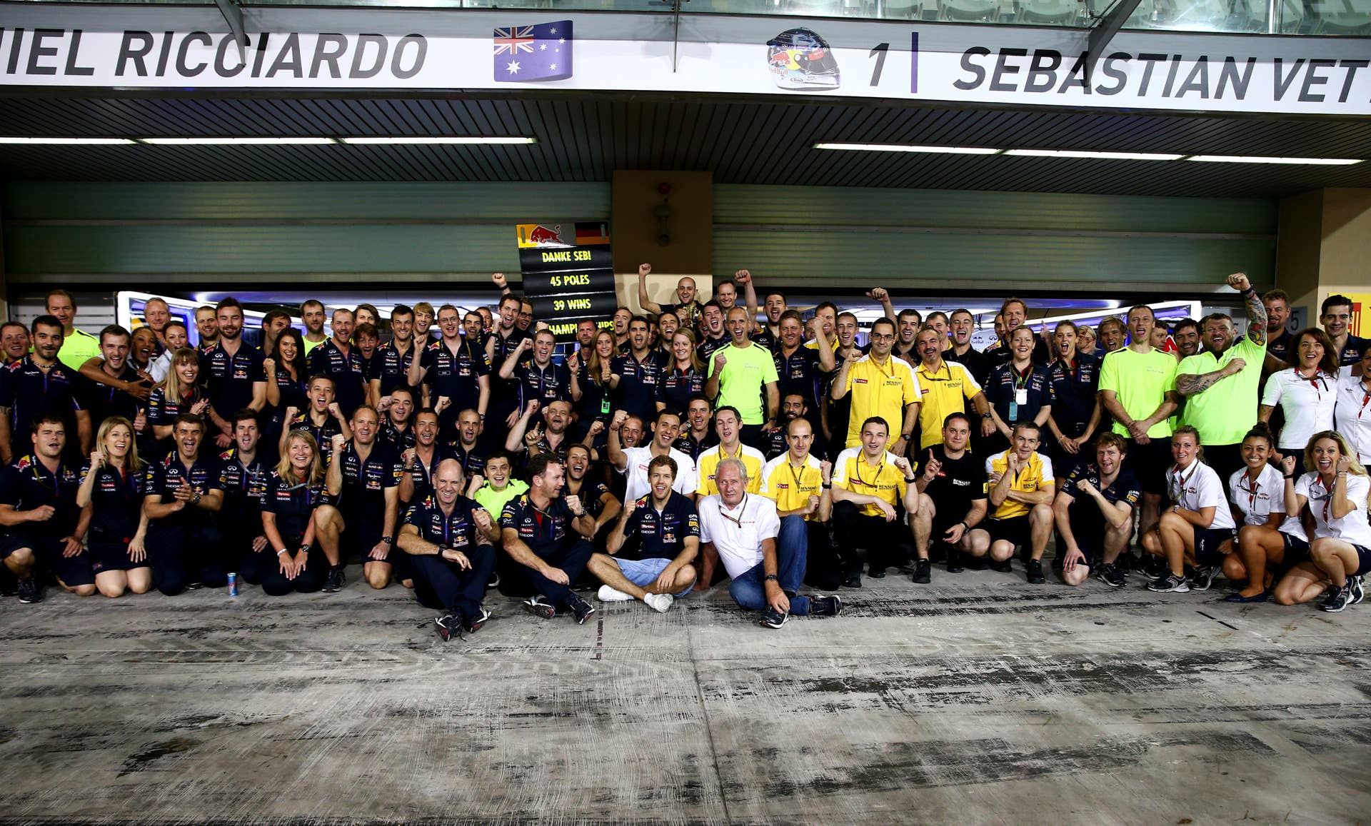 ABU DHABI, UNITED ARAB EMIRATES - NOVEMBER 23:  Sebastian Vettel of Germany and Infiniti Red Bull Racing poses with his team for a photograph after his last race with the team following the Abu Dhabi Formula One Grand Prix at Yas Marina Circuit on November 23, 2014 in Abu Dhabi, United Arab Emirates.  (Photo by Mark Thompson/Getty Images)
