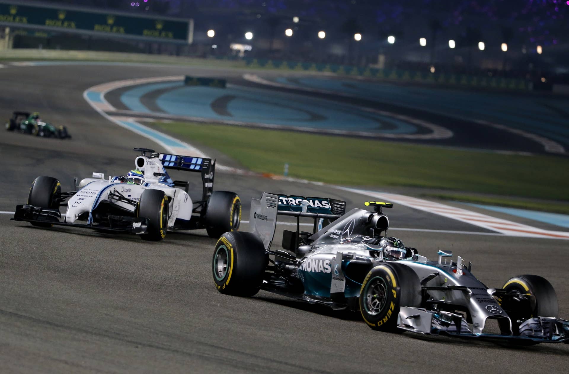 Williams' Brazilian driver  Felipe Massa and Mercedes-AMG's German driver  Nico Rosberg  races during the Abu Dhabi Formula One Grand Prix at the Yas Marina circuit on November 23, 2014.    AFP PHOTO / KARIM SAHIB        (Photo credit should read KARIM SAHIB/AFP/Getty Images)