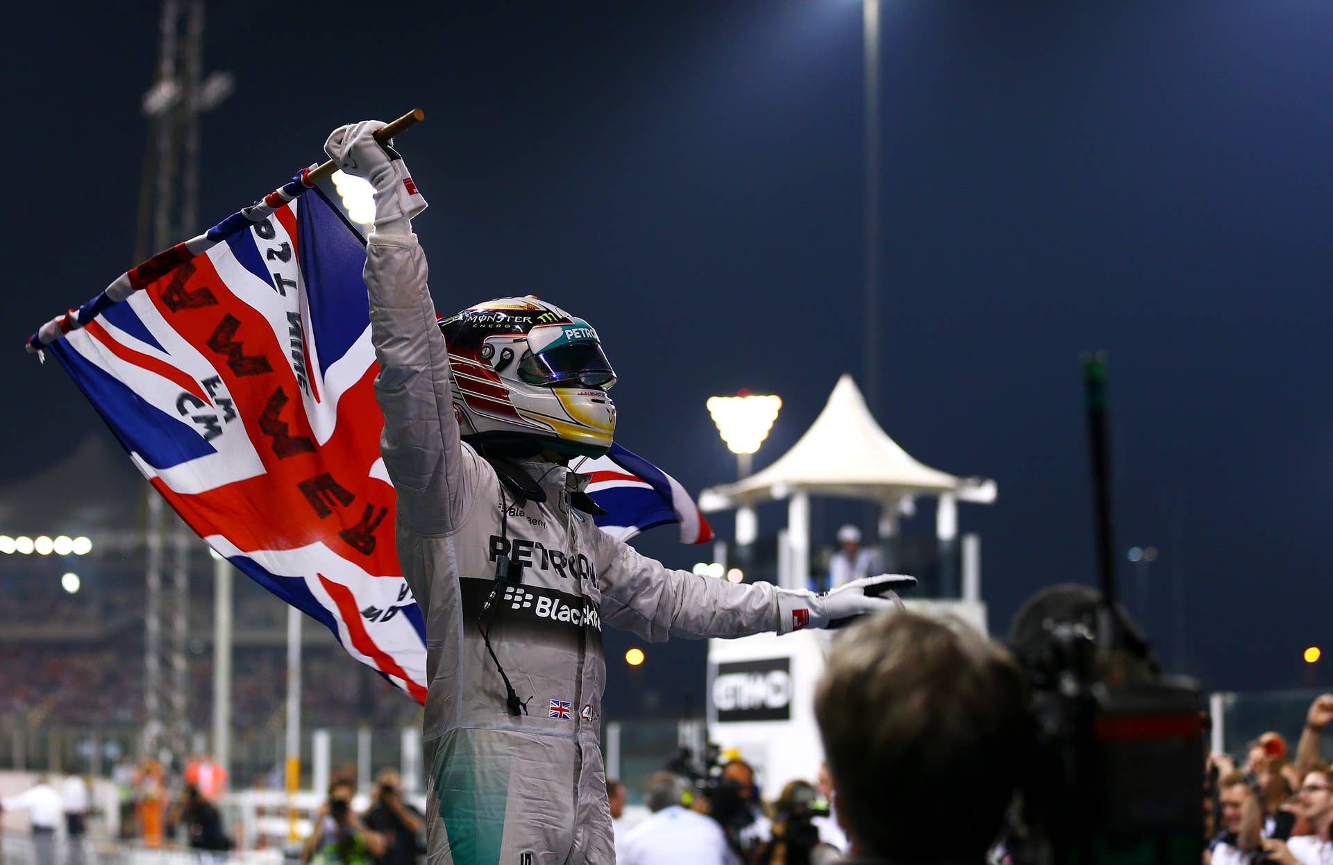 ABU DHABI, UNITED ARAB EMIRATES - NOVEMBER 23:  Lewis Hamilton of Great Britain and Mercedes GP celebrates in Parc Ferme after winning the World Championship and the Abu Dhabi Formula One Grand Prix at Yas Marina Circuit on November 23, 2014 in Abu Dhabi, United Arab Emirates.  (Photo by Dan Istitene/Getty Images)