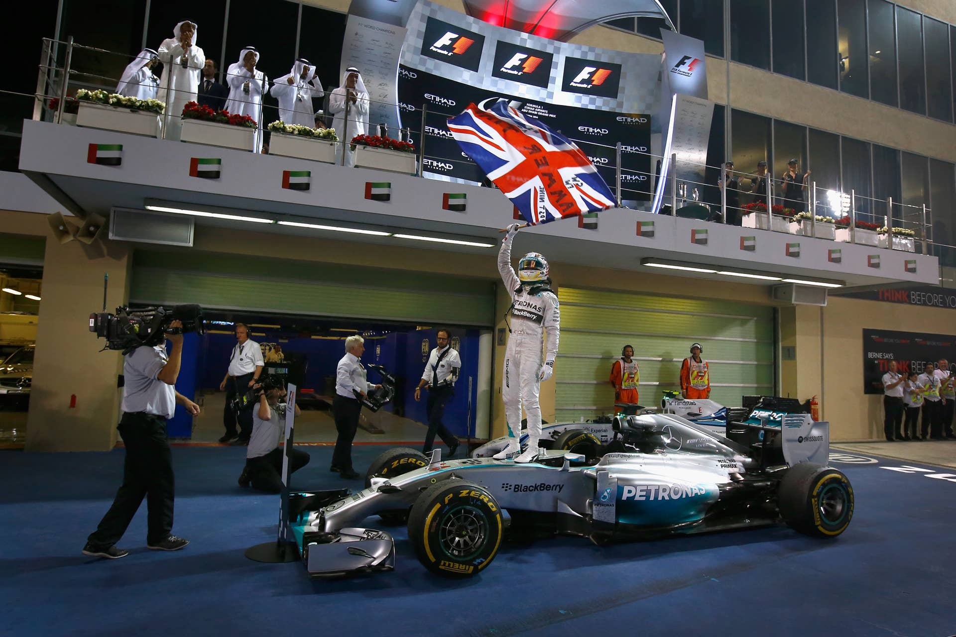ABU DHABI, UNITED ARAB EMIRATES - NOVEMBER 23:  Lewis Hamilton of Great Britain and Mercedes GP celebrates in Parc Ferme after winning the World Championship and the Abu Dhabi Formula One Grand Prix at Yas Marina Circuit on November 23, 2014 in Abu Dhabi, United Arab Emirates.  (Photo by Clive Rose/Getty Images)