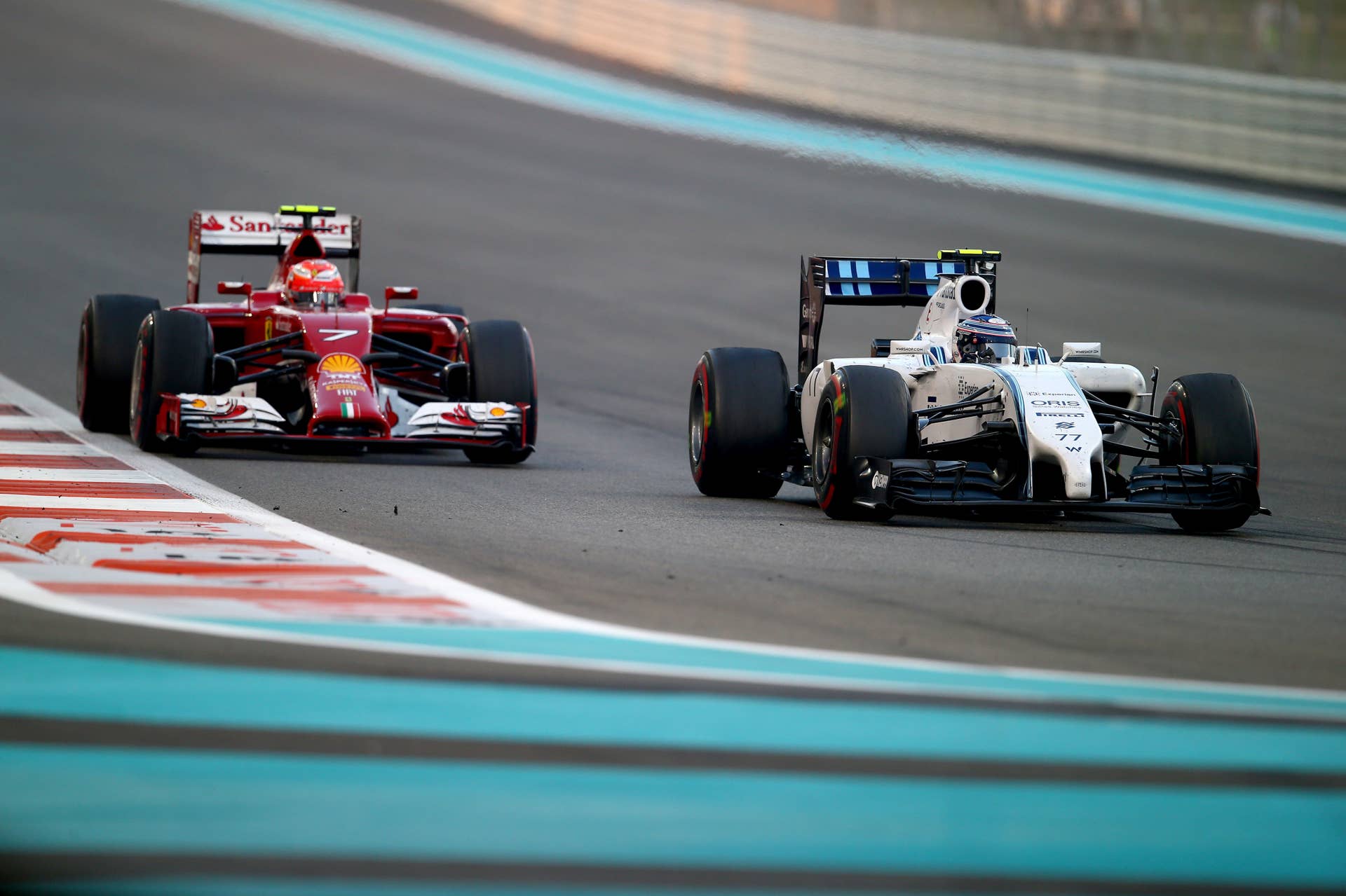 ABU DHABI, UNITED ARAB EMIRATES - NOVEMBER 23:  Kimi Raikkonen of Finland and Ferrari drives next to Valtteri Bottas of Finland and Williams  during the Abu Dhabi Formula One Grand Prix at Yas Marina Circuit on November 23, 2014 in Abu Dhabi, United Arab Emirates.  (Photo by Clive Rose/Getty Images)