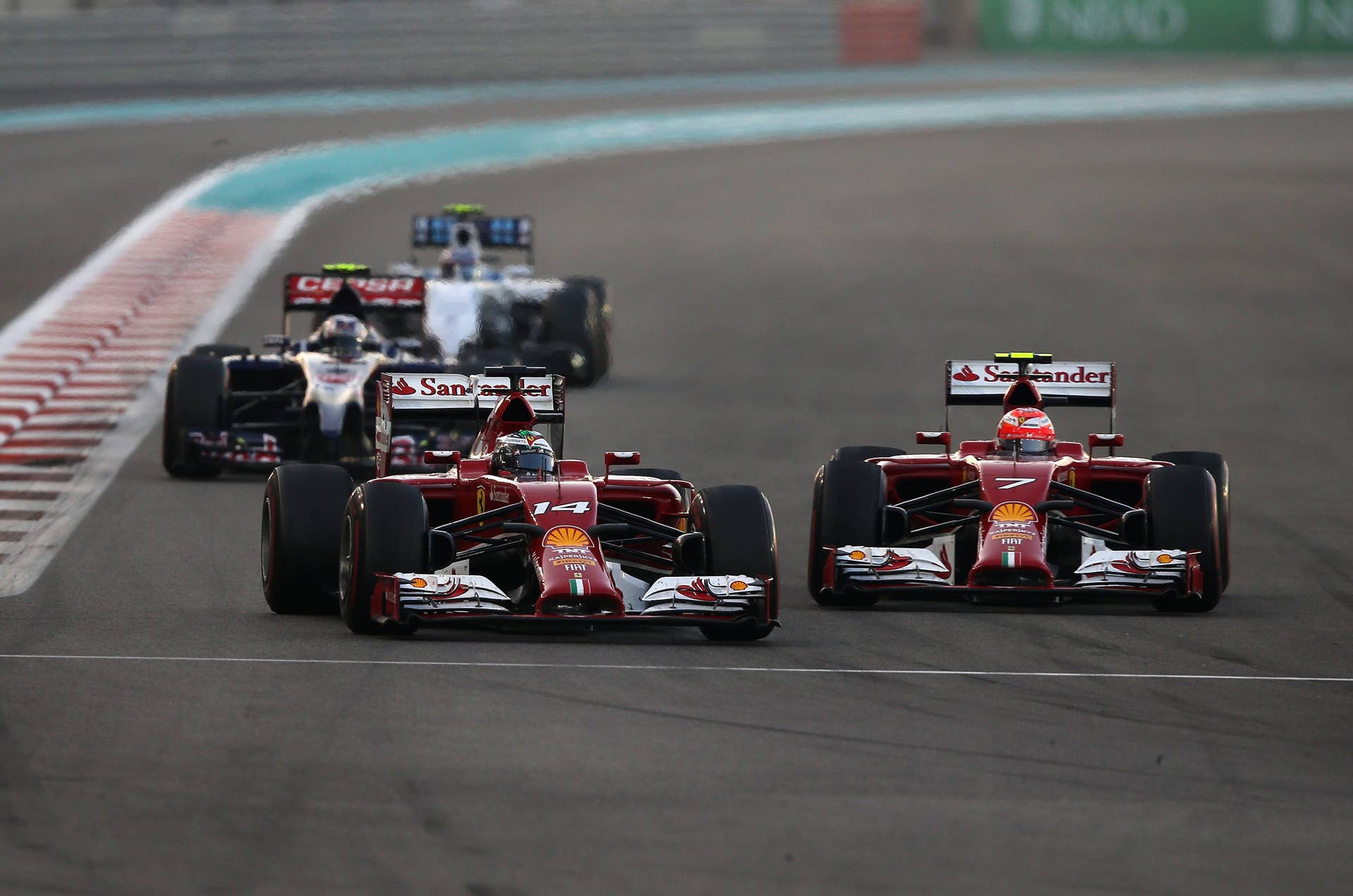 ABU DHABI, UNITED ARAB EMIRATES - NOVEMBER 23:  Fernando Alonso of Spain and Ferrari and Kimi Raikkonen of Finland and Ferrari drive during the Abu Dhabi Formula One Grand Prix at Yas Marina Circuit on November 23, 2014 in Abu Dhabi, United Arab Emirates.  (Photo by Clive Mason/Getty Images)