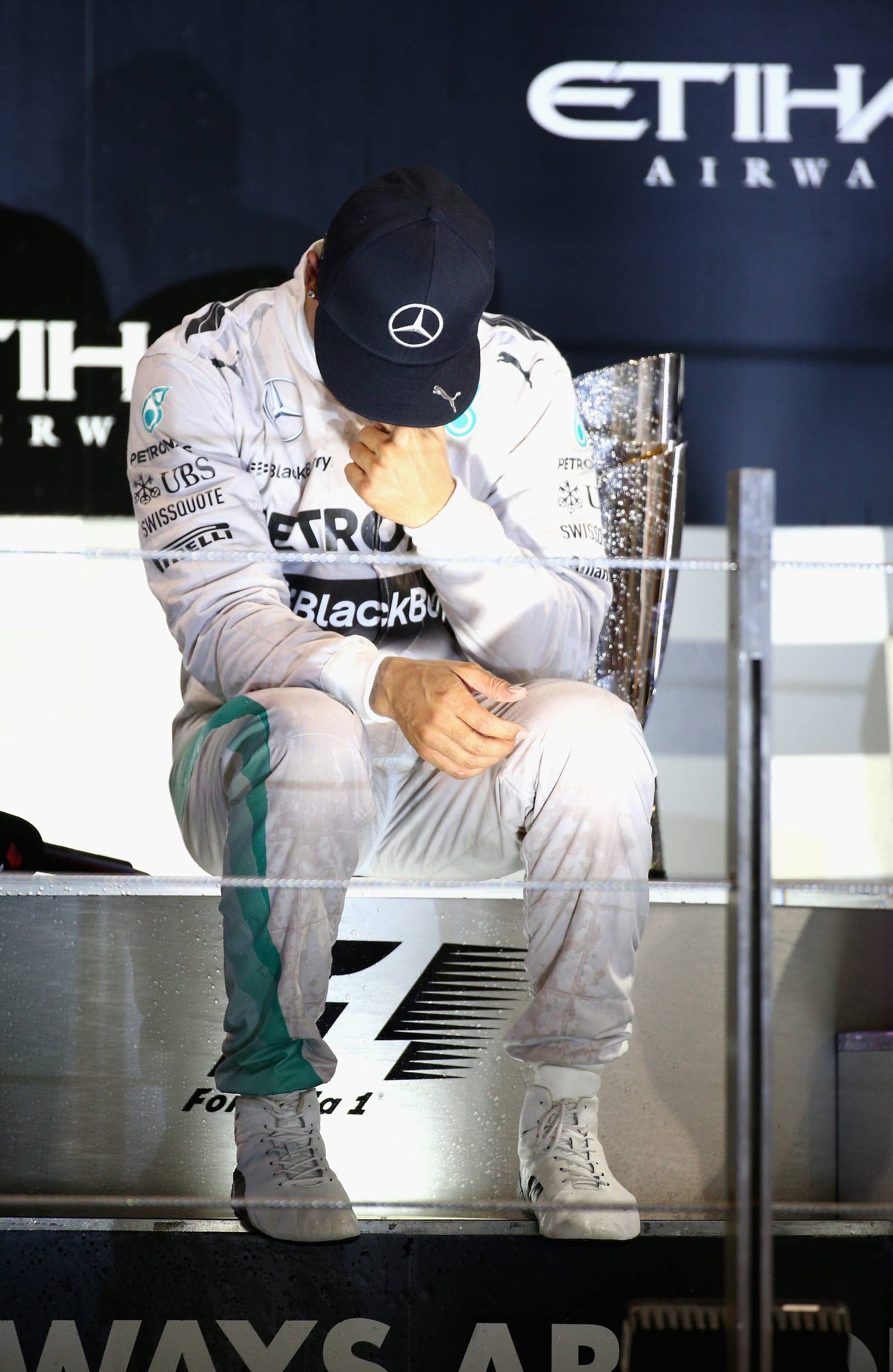 ABU DHABI, UNITED ARAB EMIRATES - NOVEMBER 23:  Lewis Hamilton of Great Britain and Mercedes GP celebrates on the podium after winning the World Championship and the Abu Dhabi Formula One Grand Prix at Yas Marina Circuit on November 23, 2014 in Abu Dhabi, United Arab Emirates.  (Photo by Mark Thompson/Getty Images)