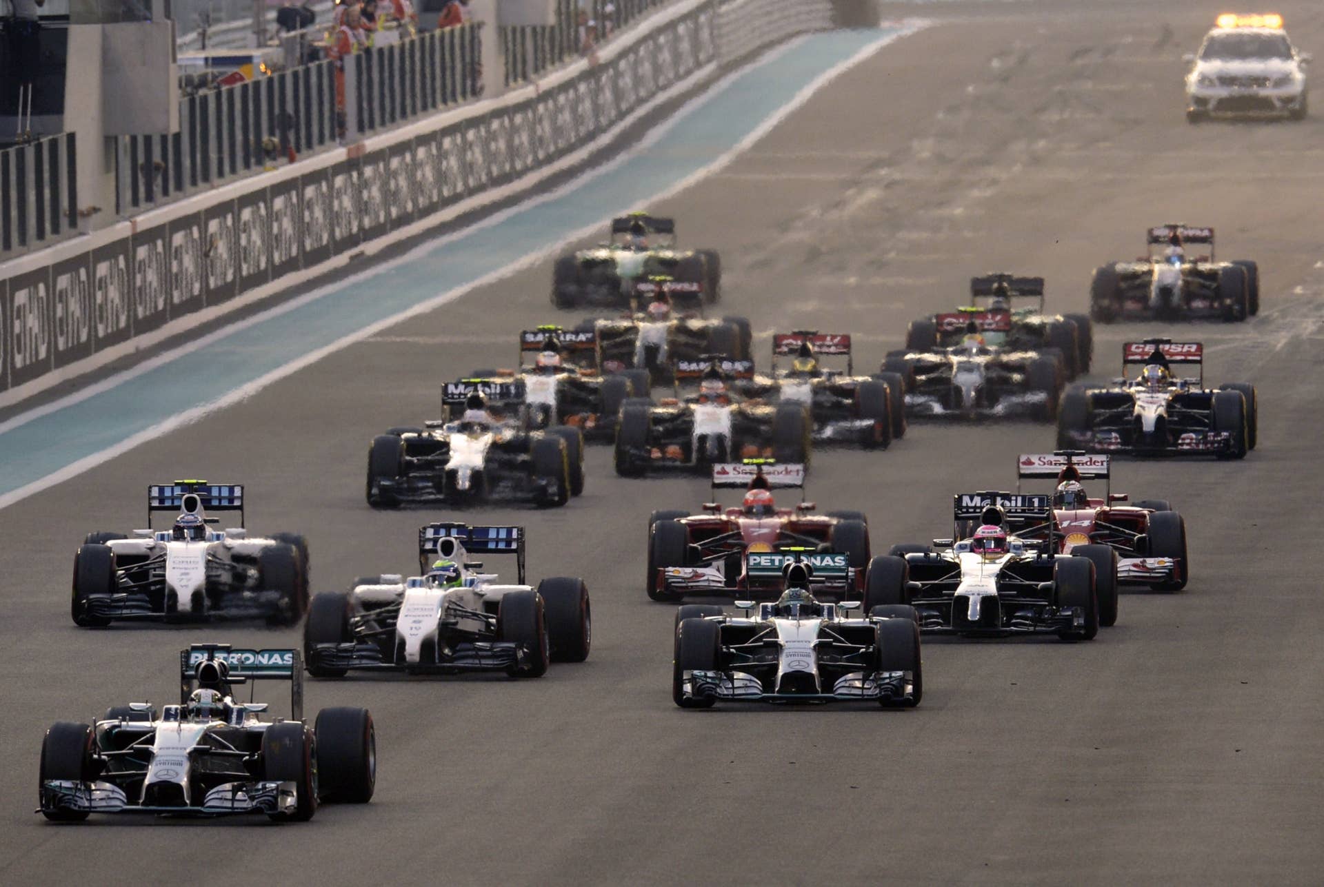 Mercedes-AMG's British driver Lewis Hamilton leads after the start of the of the Abu Dhabi Formula One Grand Prix at the Yas Marina circuit on November 23, 2014.  AFP PHOTO / TOM GANDOLFINI        (Photo credit should read Tom Gandolfini/AFP/Getty Images)