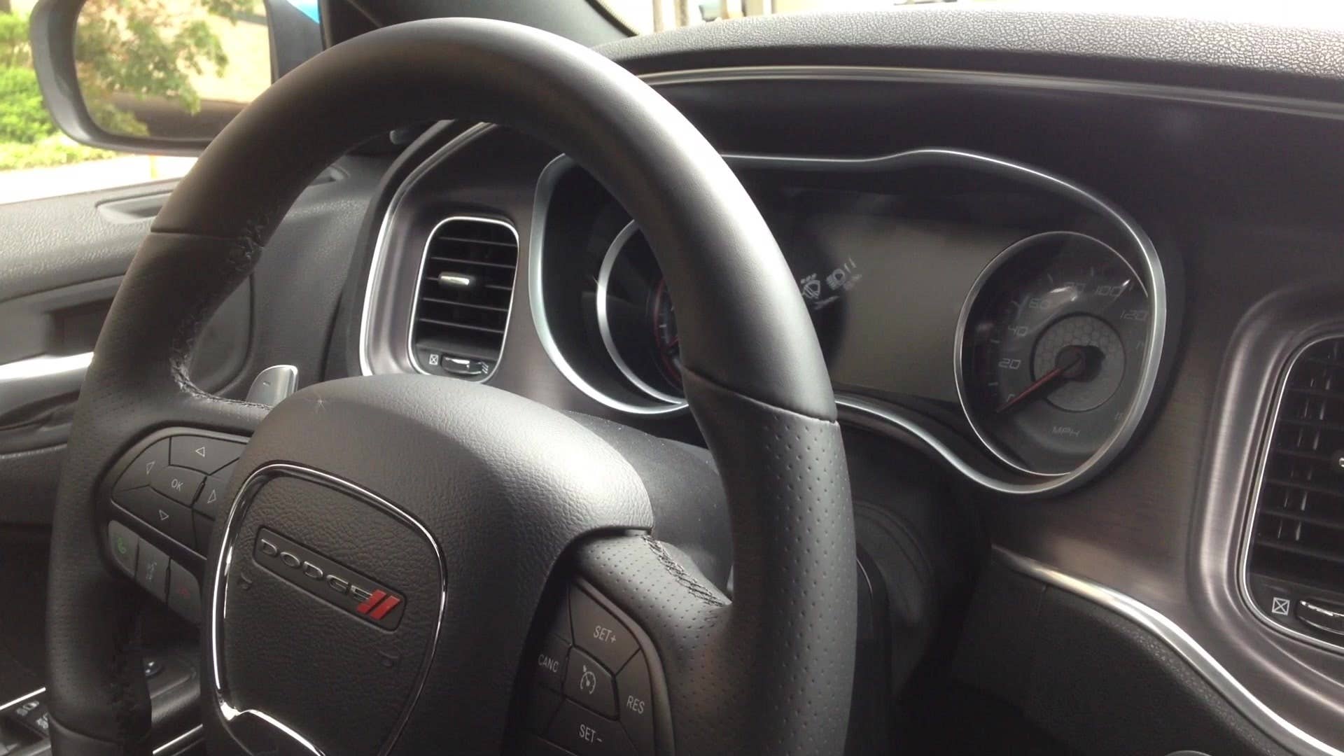 Senior editor Greg Migliore shows off the interior of the 2015 Dodge Charger R/T Scat Pack.