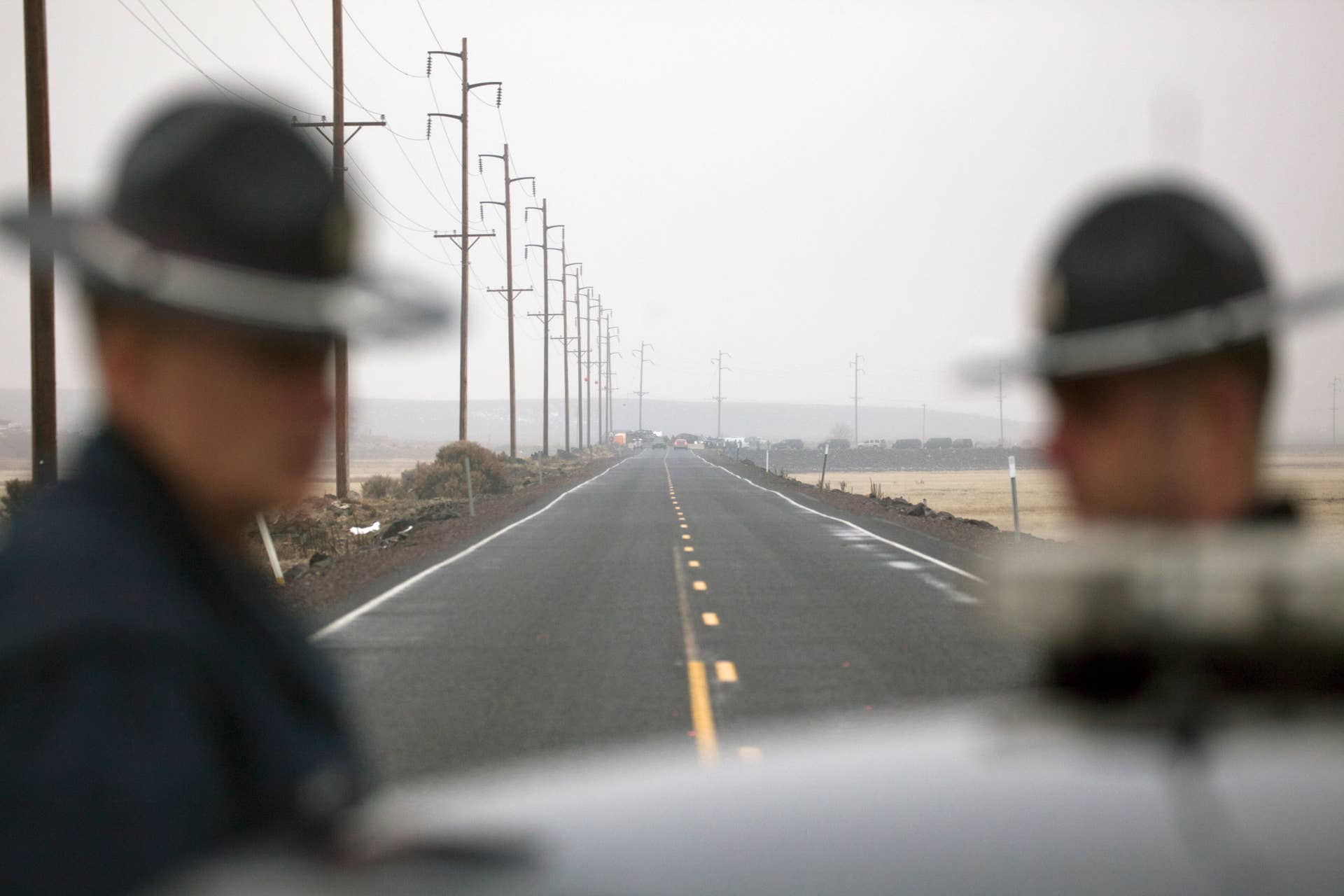 BURNS, OR - JANUARY 28: Oregon State Troopers block a road entering the Malheur National Wildlife headquarters, as a large group of law enforcement officials congregate at a checkpoint on the Malheur National Wildlife Refuge January 28, 2016 near Burns, Oregon. On January 26 eight protestors who have been occupying the refuge were arrested and one, LaVoy Finicum, was killed when the police attempted a traffic stop on U.S. 395 in a desolate area away from the refuge. The protestors first took over the Malheur National Wildlife Refuge on January 2 to protest the sentencing of two local ranchers. (Photo by Matt Mills McKnight/Getty Images)