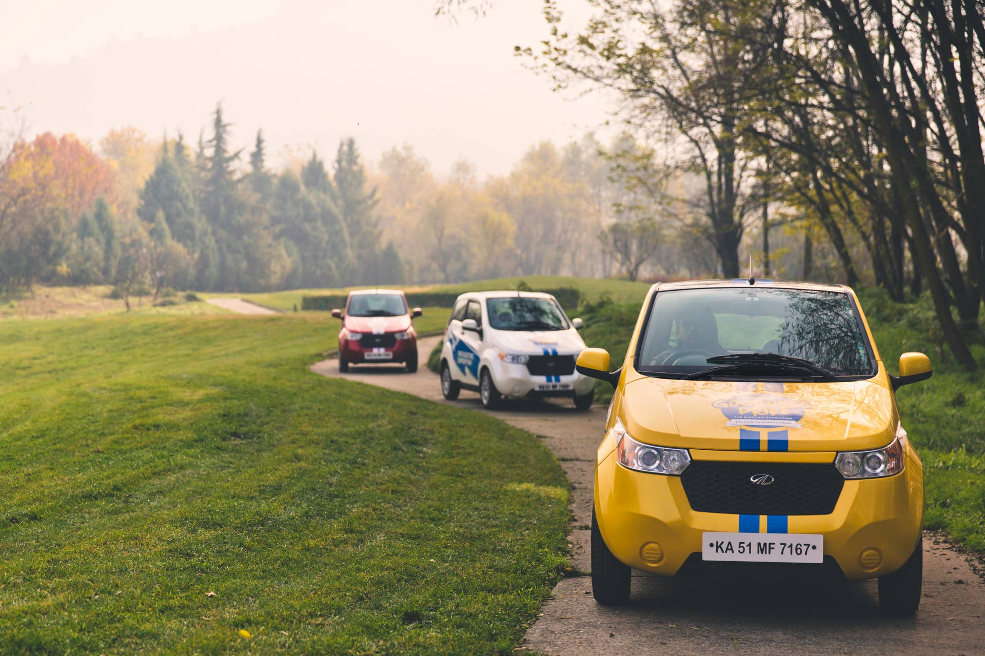 Three REVA EVs on a path during the Mahindra Electric Expedition.