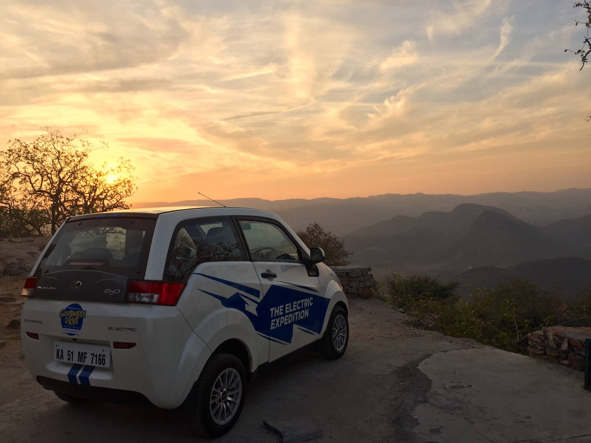 A REVA EV backed by a sunset during the Mahindra Electric Expedition.