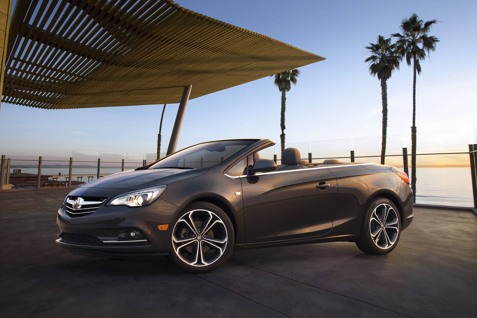 Buick Cascada Convertible, still ¾ front angle with roof down. Vehicle is shown in Technical Grey exterior color, ebony leather interior and 20-inch wheels.