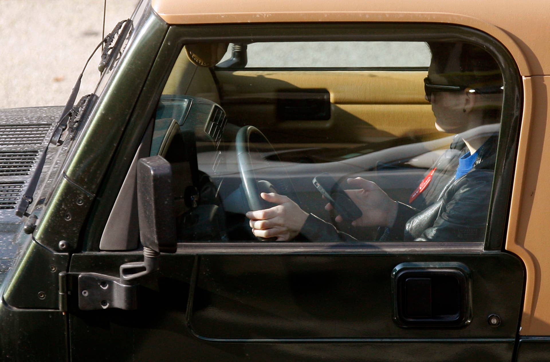 NEW YORK, NY - APRIL 30: A driver uses a phone while behind the wheel of a car on April 30, 2016 in New York City. As accidents involving drivers using phones or other personal devices mount across the country, New York lawmakers have proposed a new test called the Textalyzer to help curb mobile phone usage behind the wheel. Similar to a Breathalyzer test, the Textalyzer would allow police to request phones from drivers involved in accidents and then determine if the phone had been used while the drivers operated their vehicles. The controversial bill is currently in the early committee stage. According to statistics, In 2014 431,000 people were injured and 3,179 were killed in car accidents involving distracted drivers. (Photo by Spencer Platt/Getty Images)