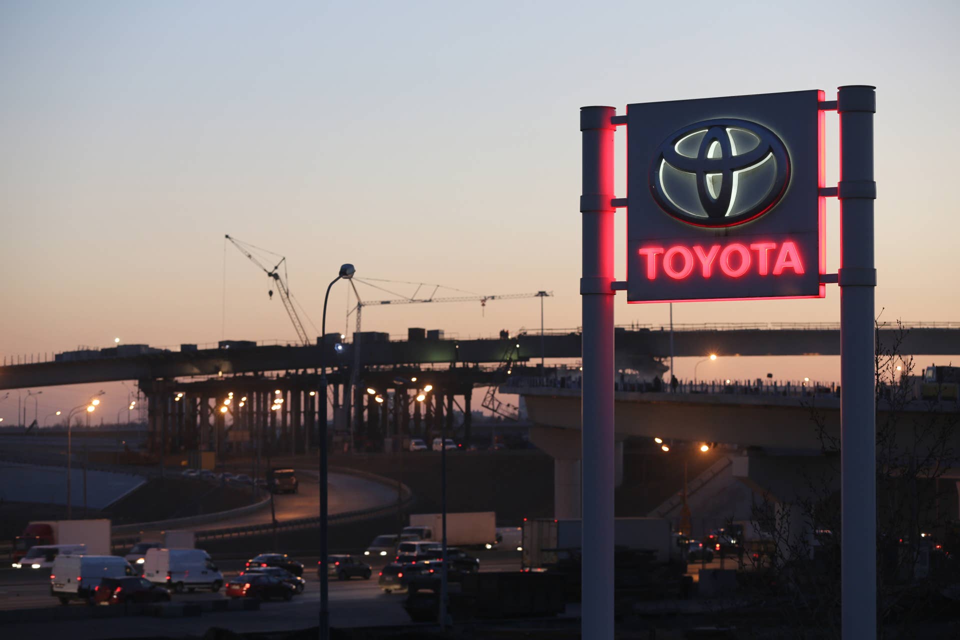 Road traffic passes along highways beyond a Toyota Motor Corp. automobile dealership in Moscow, Russia, on Tuesday, Nov. 18, 2014. A recession is imminent, inflation is getting out of hand and the ruble and oil are in freefall, Economy Minister Alexei Ulyukayev told Russia's President Vladimir Putin, according to people who attended the meeting at the presidential mansion near Moscow in mid-October. Photographer: Andrey Rudakov/Bloomberg via Getty Images