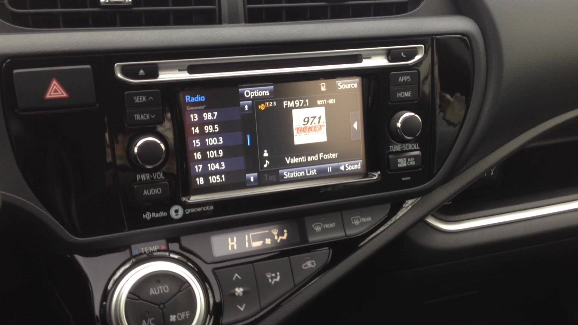 Greg Migliore shows off the interior of the 2015 Toyota Prius C.