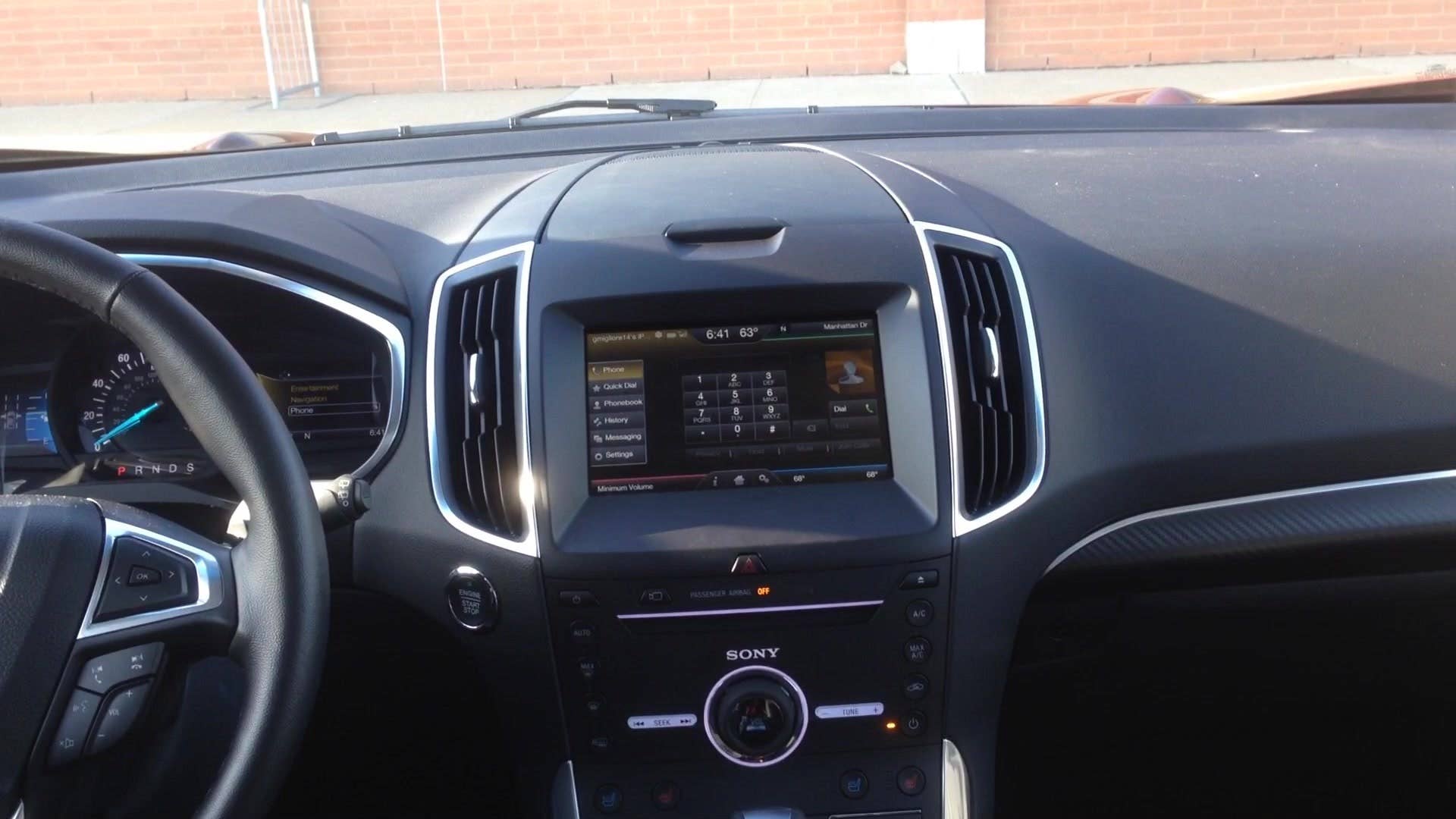 Senior Editor Greg Migliore shows off the interior of the 2015 Ford Edge Sport.
