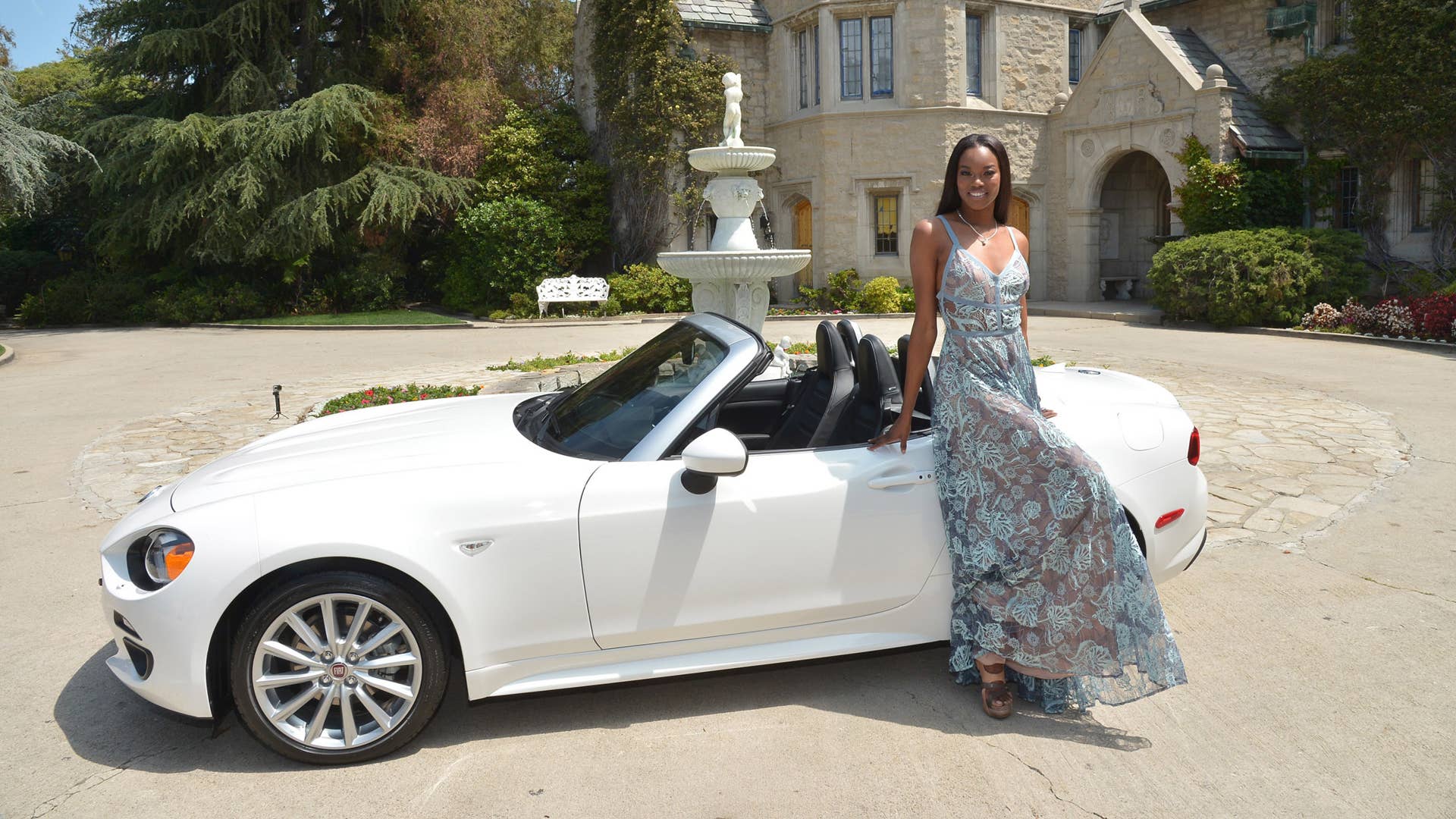 Eugena Washington with Fiat 124 Spider Playboy Mansion