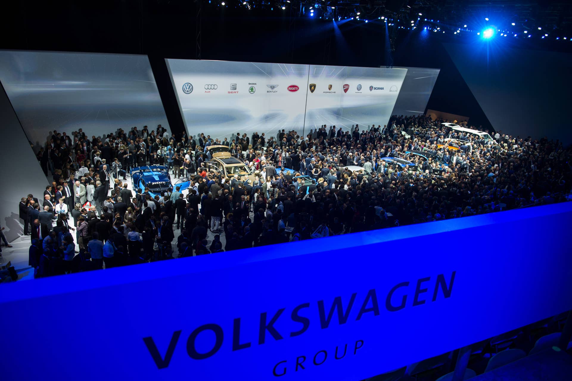 People mill around new cars from the Volkswagen group after they were unveiled at the Fraport arena prior to the 66th IAA auto show in Frankfurt am Main, western Germany on September 14, 2015. Volkswagen group showed their latest models and automotive concepts from the brands Volkswagen, Audi, Bentley, Bugatti, Ducati, Lamborghini, Porsche, Seat and Skoda. Hundreds of thousands of visitors are expected to crowd into the massive exhibition halls of Frankfurt's sprawling trade fair grounds later this week to catch a glimpse of the latest models and high tech innovations. AFP PHOTO / ODD ANDERSEN (Photo credit should read ODD ANDERSEN/AFP/Getty Images)