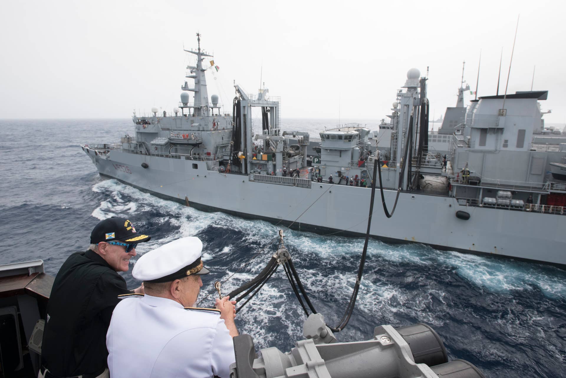 MEDITERRANEAN SEA - JUNE 16: Secretary of the Navy (SECNAV) Ray Mabus, left, observes an underway replenishment with Adm. Giuseppe De Giorgi, chief of the Italian navy, while aboard the guided-missile destroyer USS Mason (DDG 87). This was the U.S. Navys first underway replenishment where the fuel was made from alternative sources and transferred from a partner nations ship. The Italian navy auxiliary ship ITS Etna (A5326) provided Mason with biofuel, made from waste fat beef and inedible vegetable oil, as part of the Great Green Fleet initiative.(Photo by Armando Gonzales/US Navy/Getty Images)