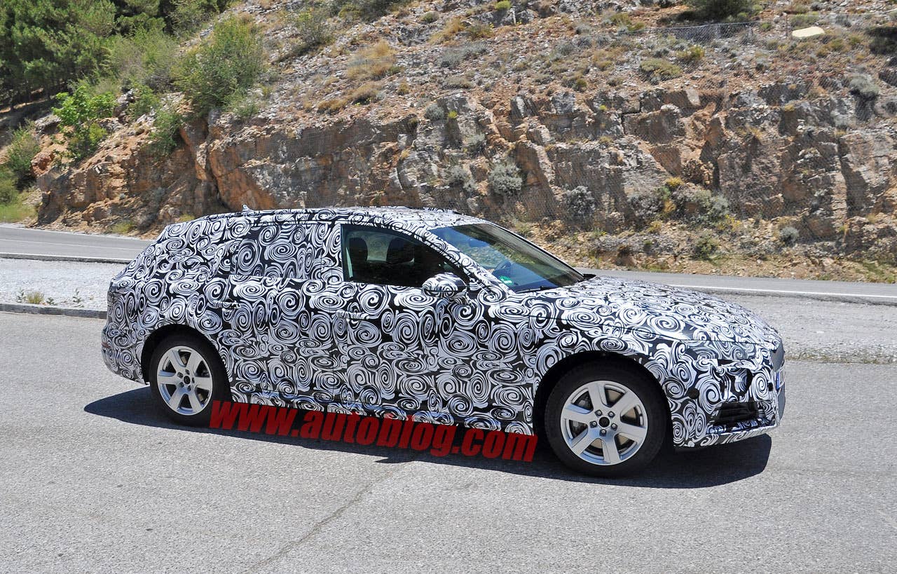 camouflaged audi a4 allroad spy shots front three quarters