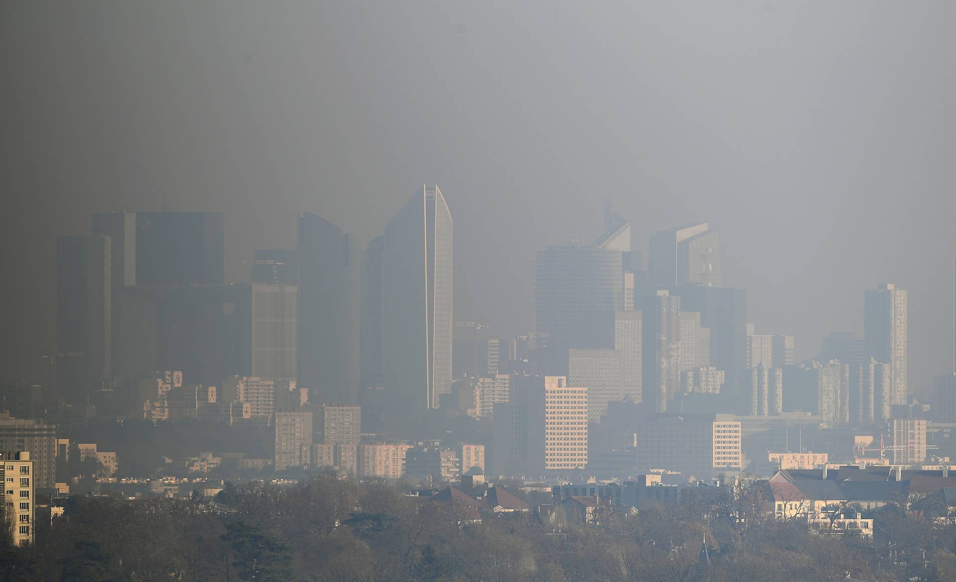 A picture taken on December 5, 2016 from Saint-Germain-en-Laye shows a view of La Defense business in a smog, on December 5, 2016. Pollution reaches a peak in Paris on December 5, 2016 / AFP / FRANCK FIFE (Photo credit should read FRANCK FIFE/AFP/Getty Images)