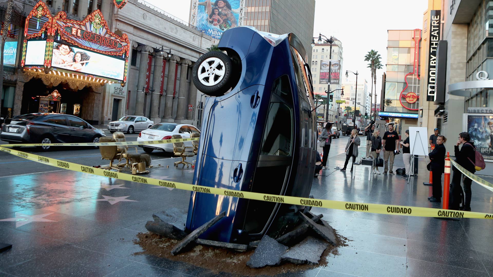 HOLLYWOOD, CA - NOVEMBER 15: A car 'crashed' into the ground on November 15, 2016 at the Walk of Fame in Hollywood, California, ahead of the launch of Jeremy Clarkson, Richard Hammond and James May's new show, 'The Grand Tour', on Amazon Prime Video, on Friday. (Photo by Randy Shropshire/Getty Images for Amazon Prime Video)