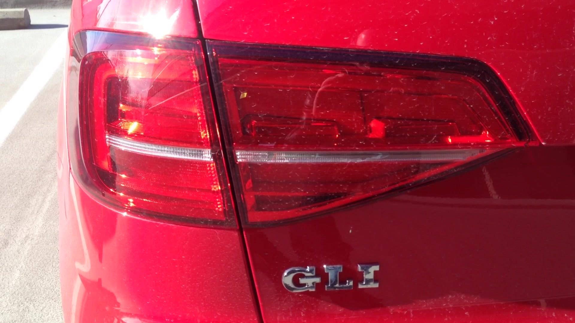 Senior editor Greg Migliore shows off the taillights on the 2015 Volkswagen Jetta GLI.